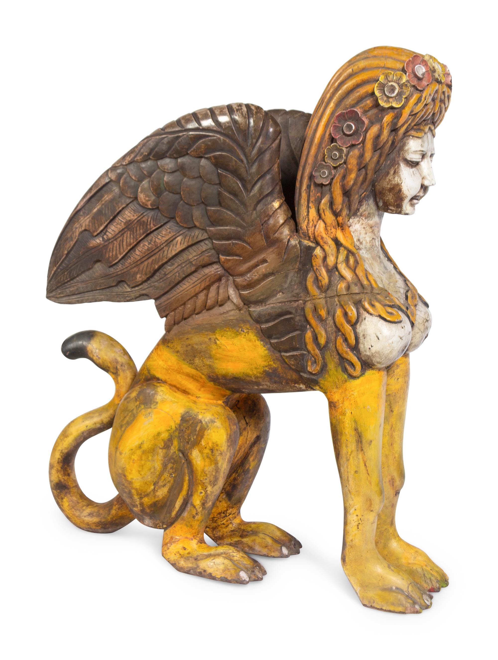 A Large Carved and Polychrome Decorated Wood Sphinx
