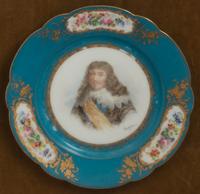 A Group of Seven Framed Sèvres Style Porcelain Plates