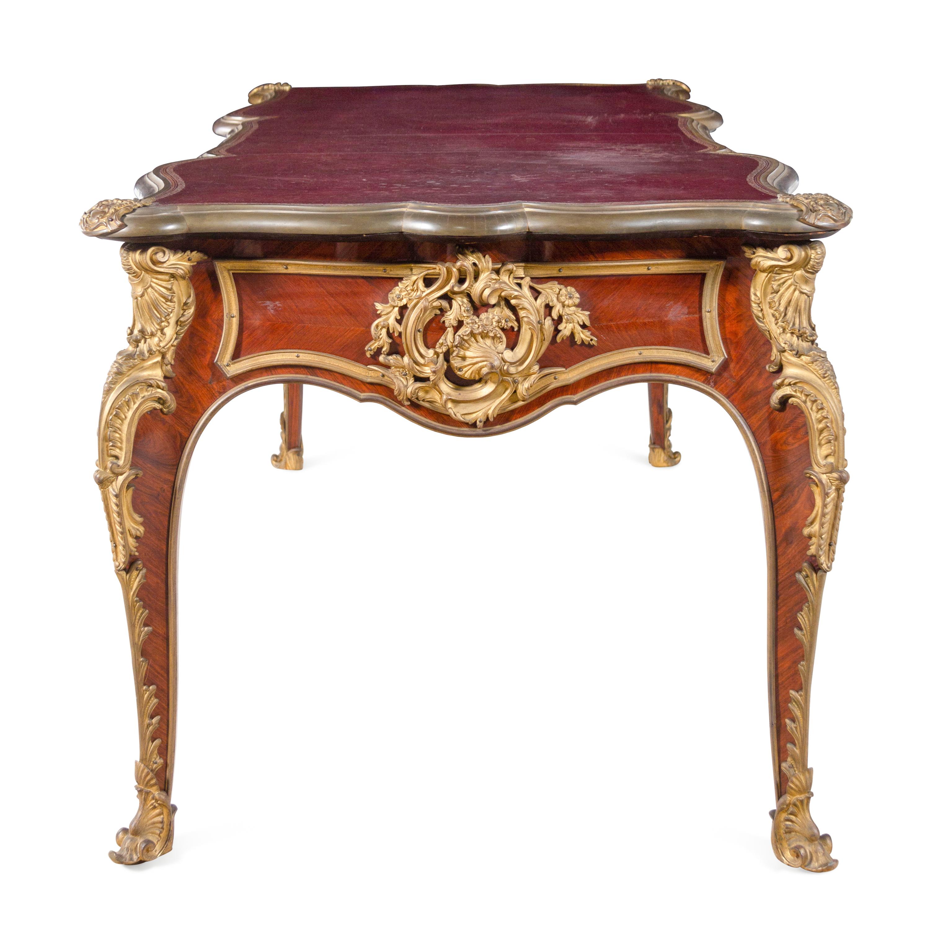 A Louis XV Style Gilt Bronze Mounted and Tooled Leather-Inset Tulipwood Bureau Plat