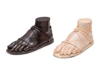 A Pair of Composition and Bronze Paw and Foot Form Doorstops