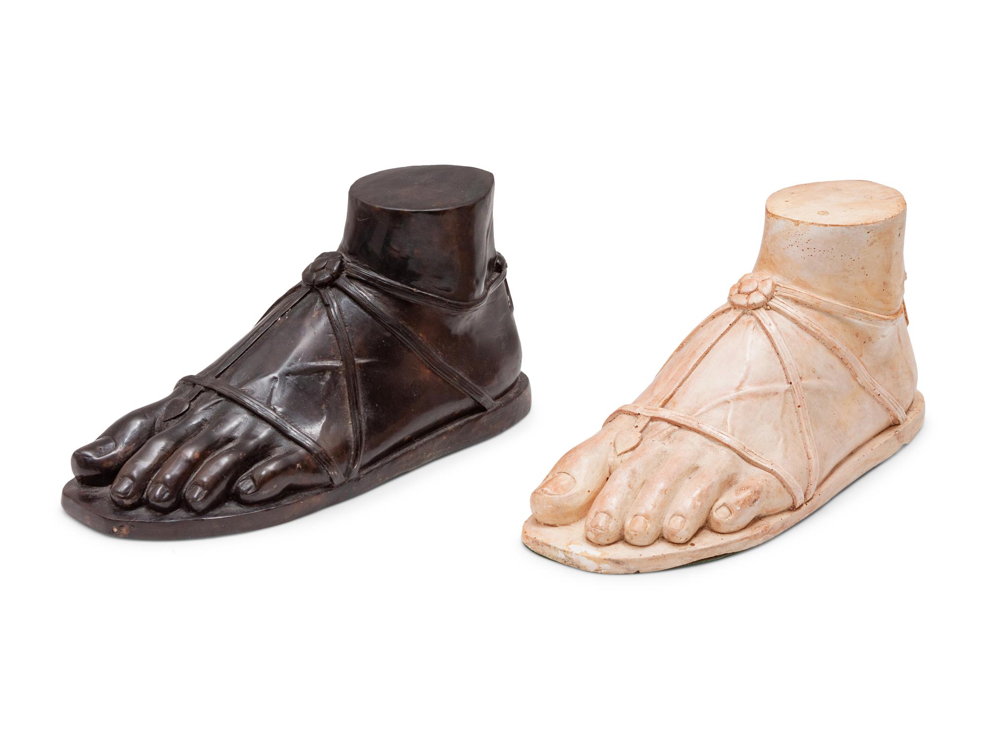 A Pair of Composition and Bronze Paw and Foot Form Doorstops