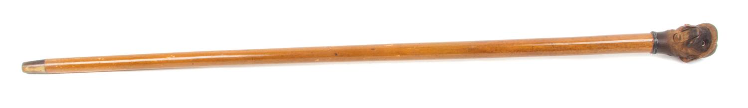 An American Carved Wood Glove Holder Cane, Length overall 35 1/2 inches.