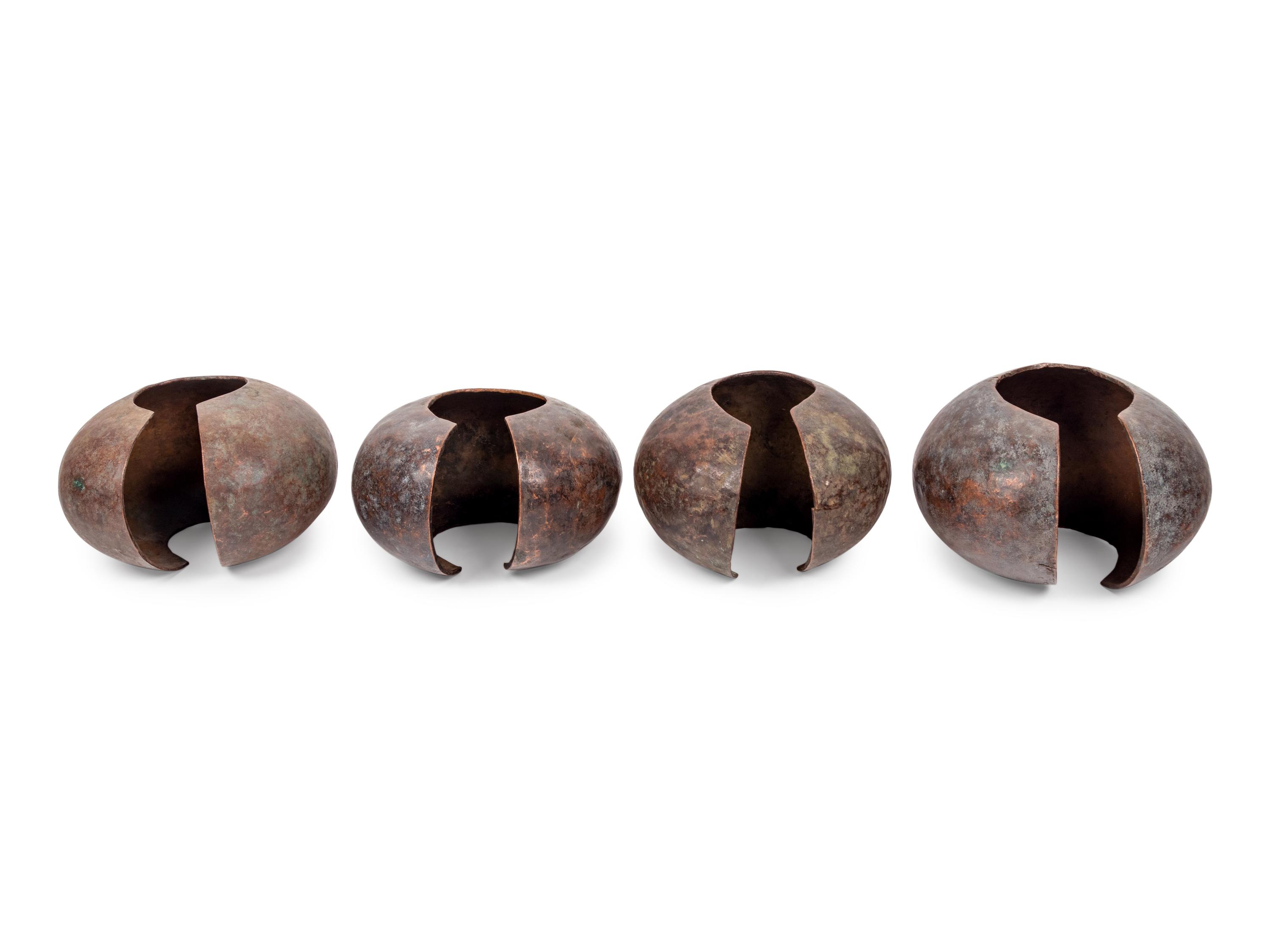 A Pair of Philippine Carved Wood Bowls and Four African Bronze Currency Bracelets on Metal Stands