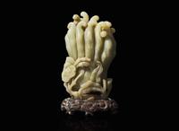 A Chinese carved celadon jade Buddha’s-hand citron with carved wood stand, Qing dynasty 玉雕佛手瓜帶底座 清