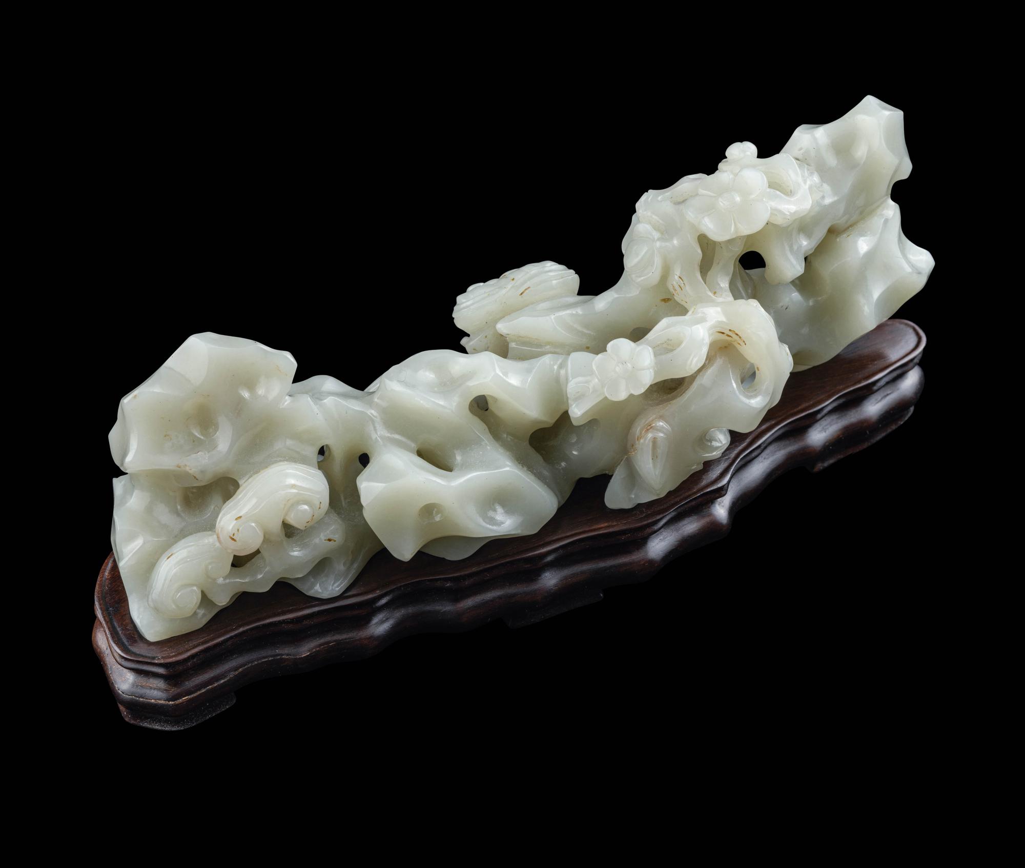 A Chinese Pale Celadon Jade ‘Lingzhi and Rockwork’ Brush Rest, 20th Century — 近代 青白玉靈芝筆架