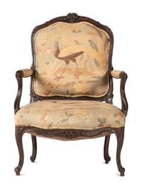 A Louis XV Carved Walnut Upholstered Fauteuil