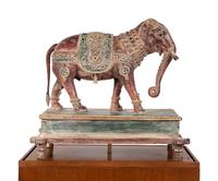 An Indian Carved Wood Model of an Elephant in a Walnut and Glass Vitrine