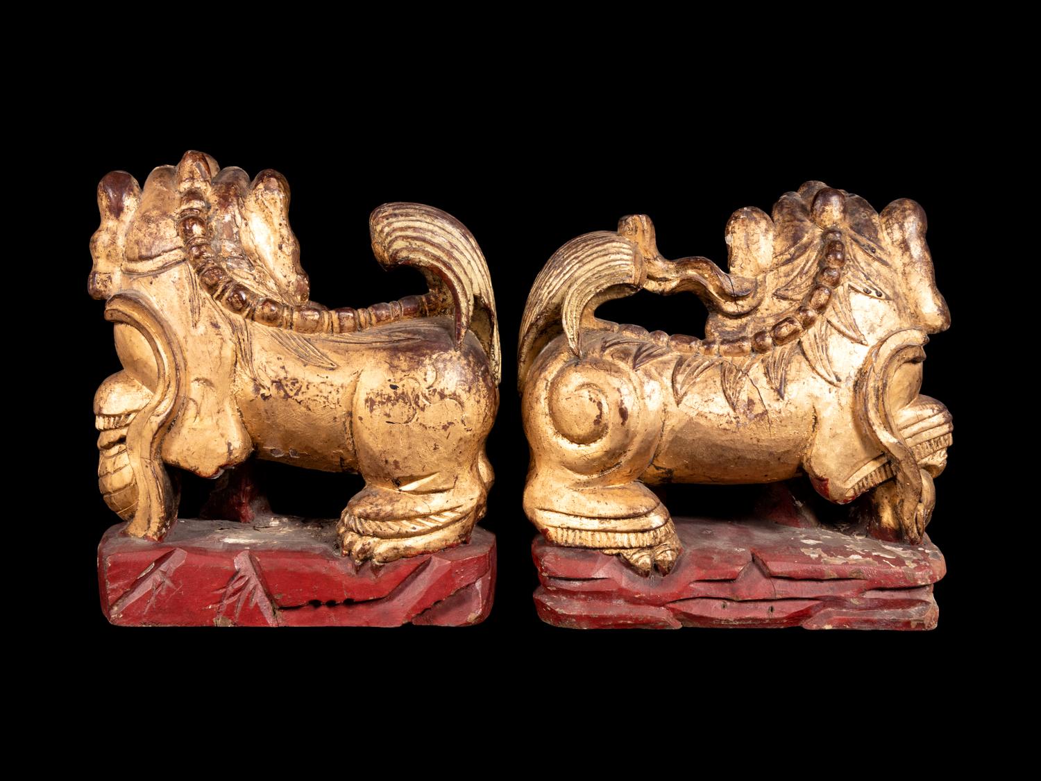 A Pair of Chinese Gilt and Red Lacquered Wood Figures of Fu Lions