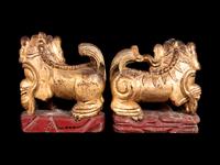 A Pair of Chinese Gilt and Red Lacquered Wood Figures of Fu Lions
