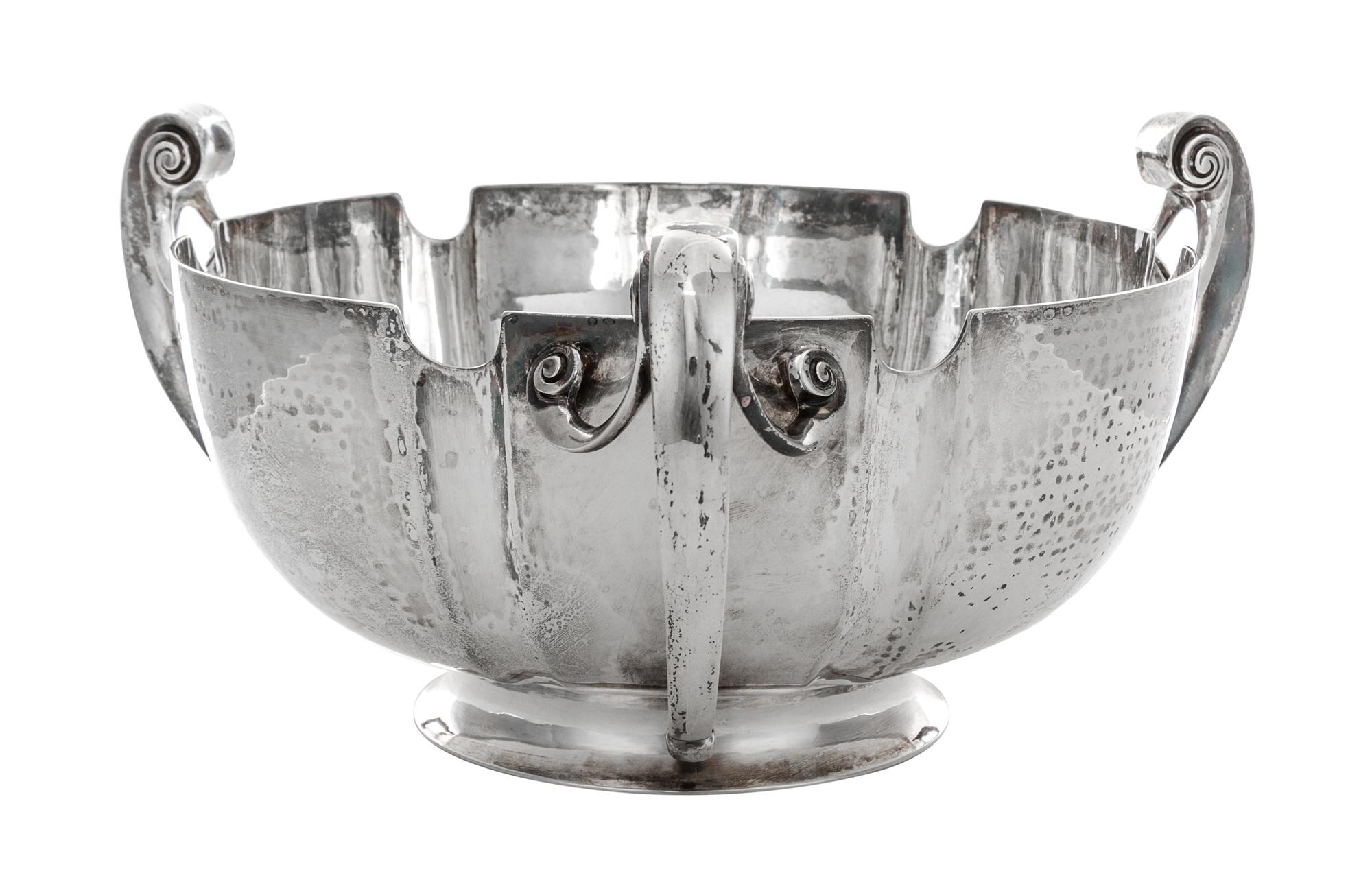 An Edwardian Silver Center Bowl, Elkington & Co., London, 1905, having three scroll handles.