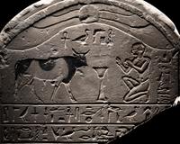 An Egyptian Limestone Round-Topped Stele