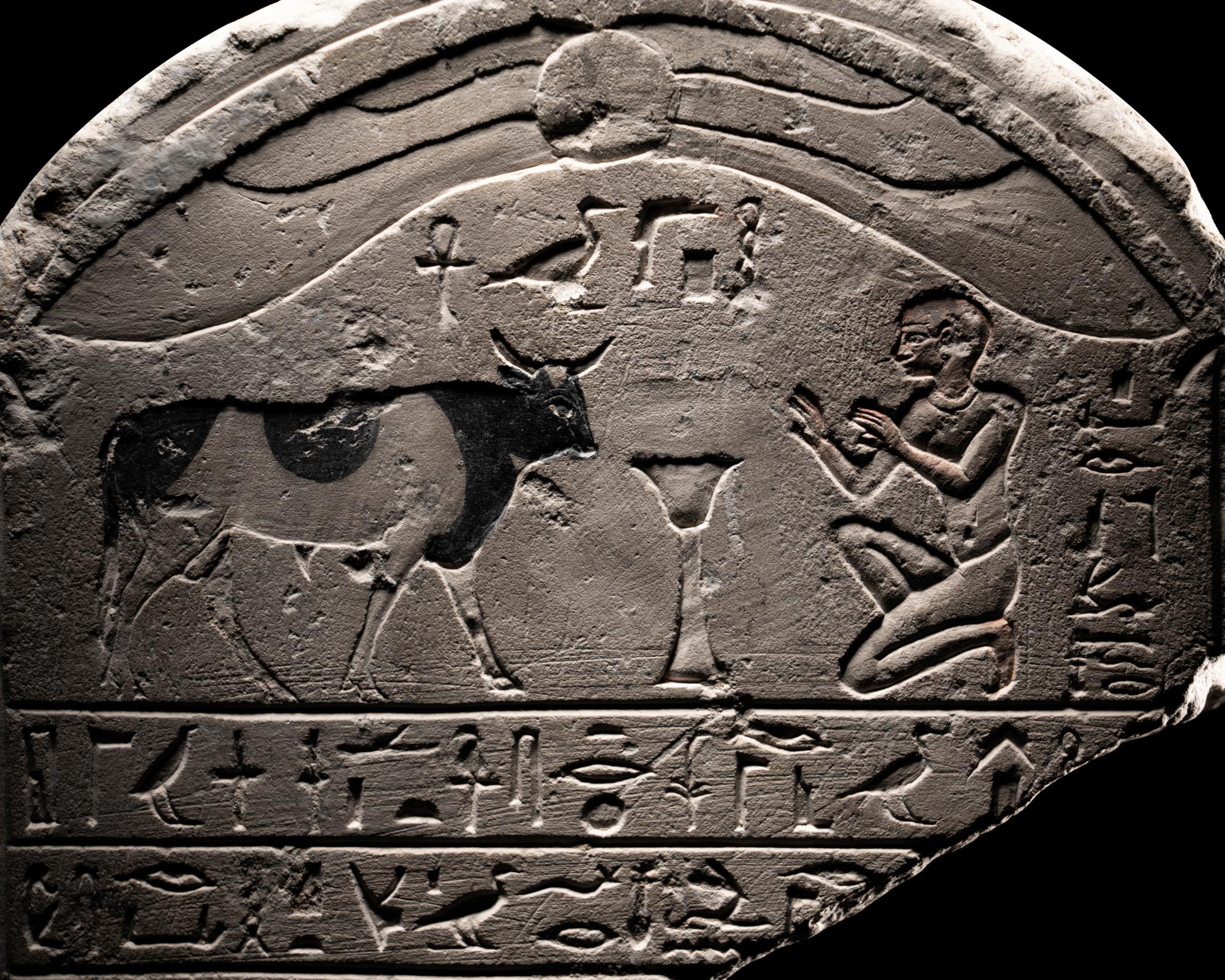 An Egyptian Limestone Round-Topped Stele