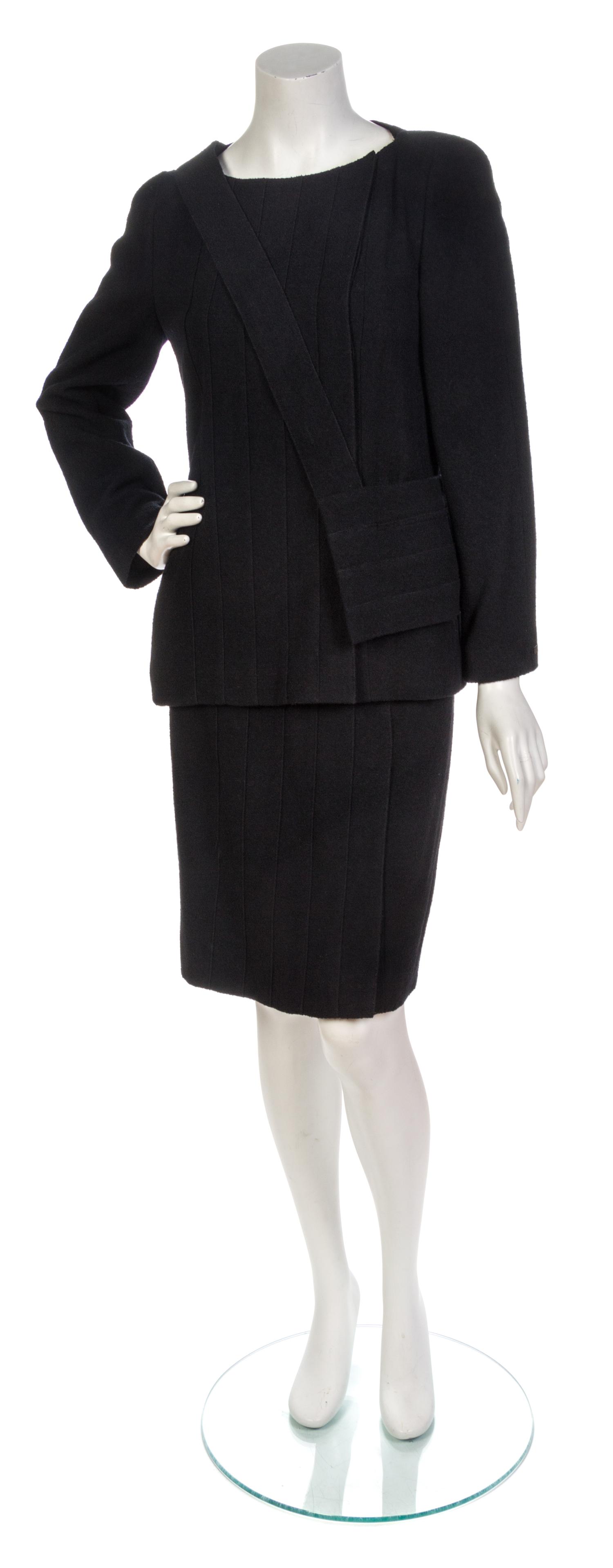 A Chanel Black Wool Boucle Skirt Suit and Bag, Jacket size 40, skirt size 40.