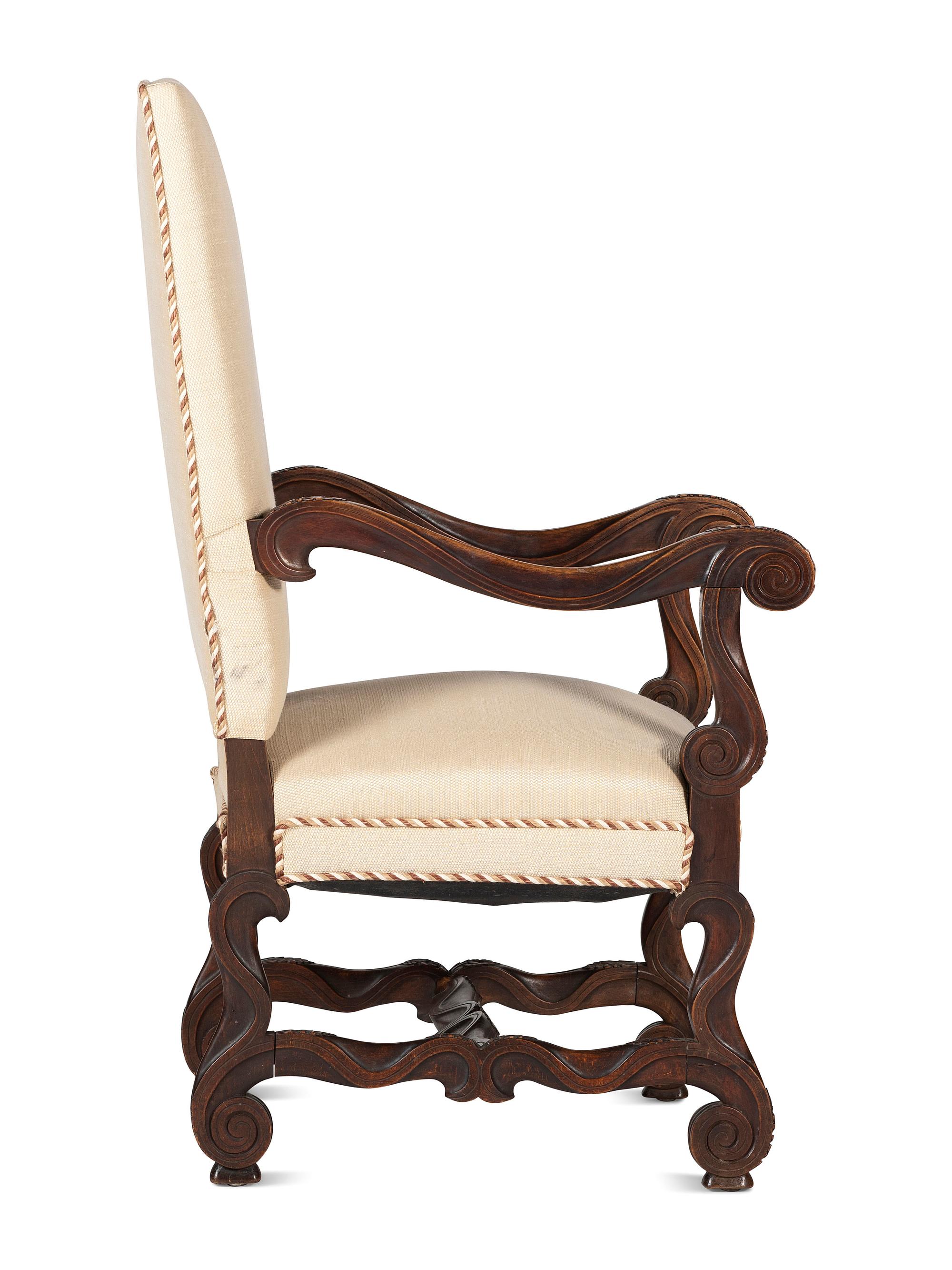 A Louis XIV Style Foliate and Scroll Carved Walnut Upholstered Fauteuil