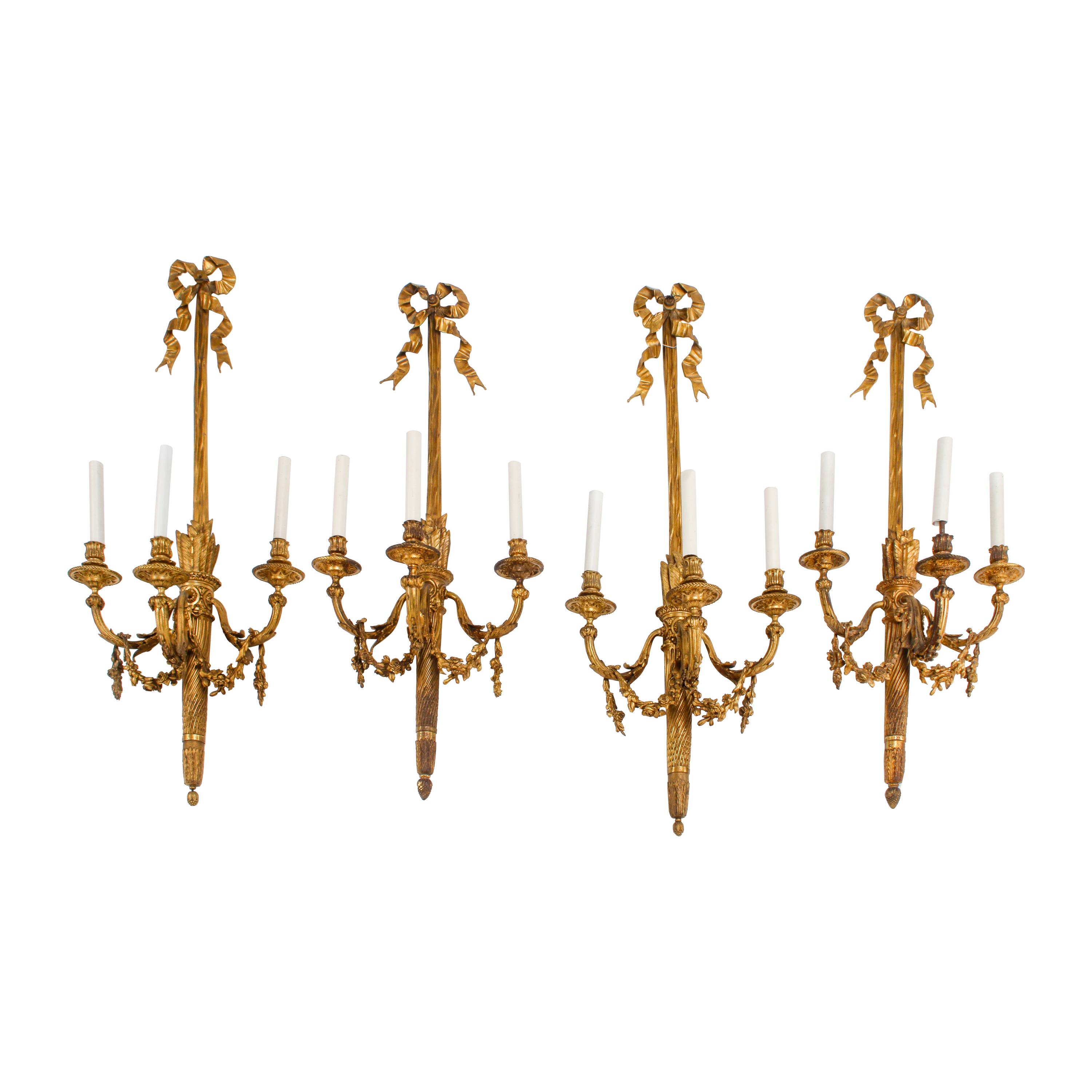 A Set of Four Louis XVI Style Gilt Bonze Three-Light Sconces