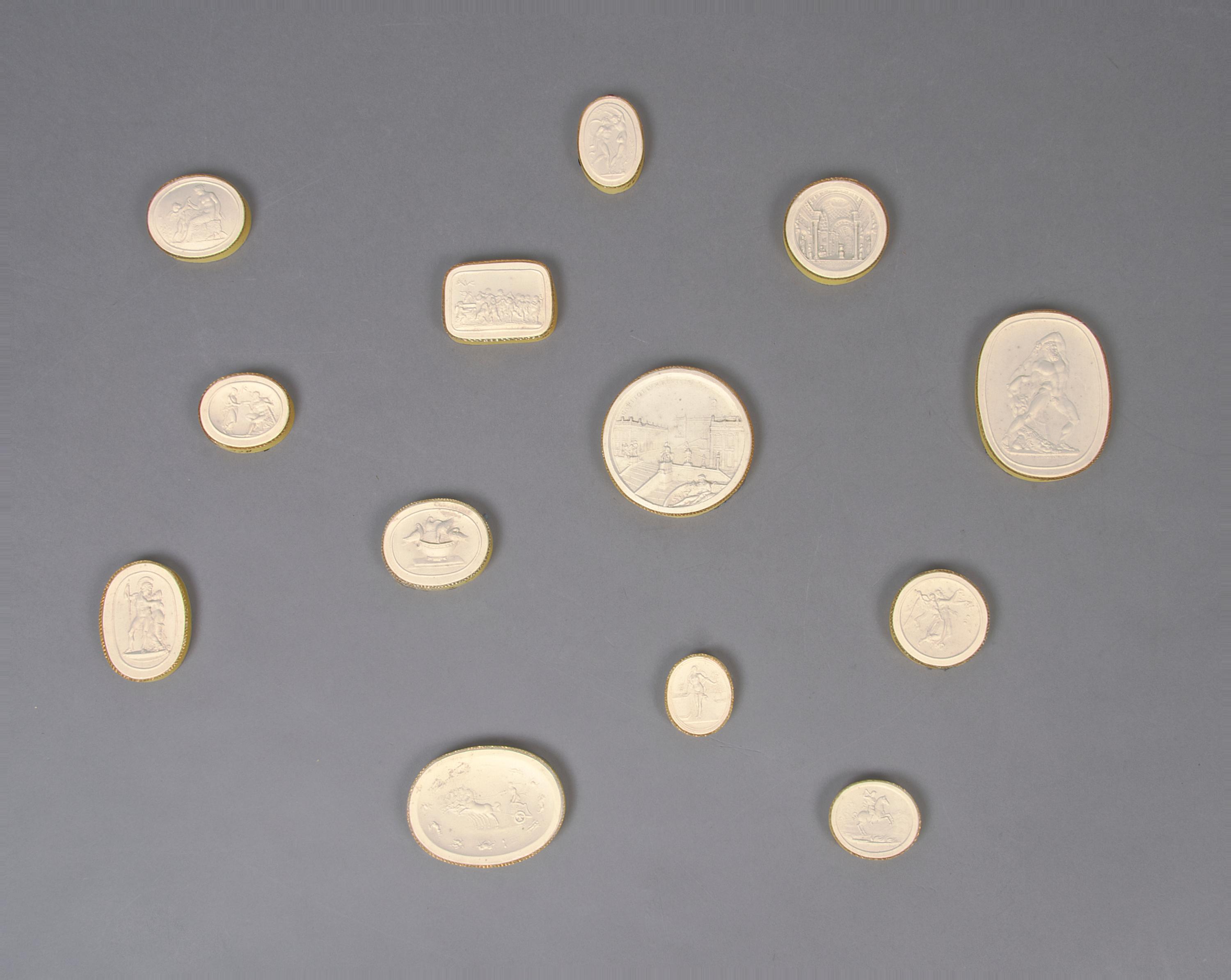 A Collection of Thirteen Plaster Medallions, Height of tallest 3 inches.
