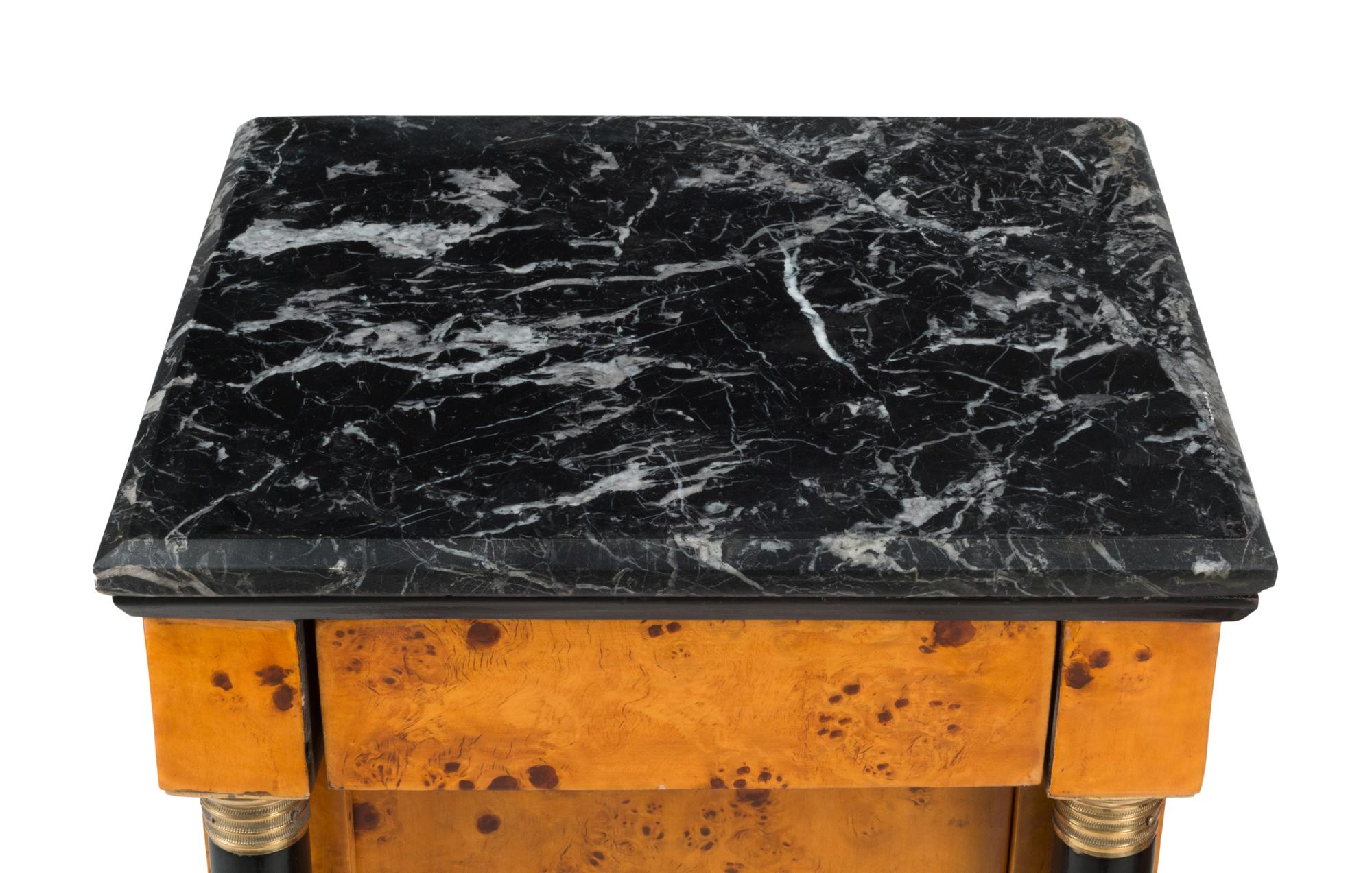A Pair of Empire Style Part-Ebonized Marble-Top Bedside Tables