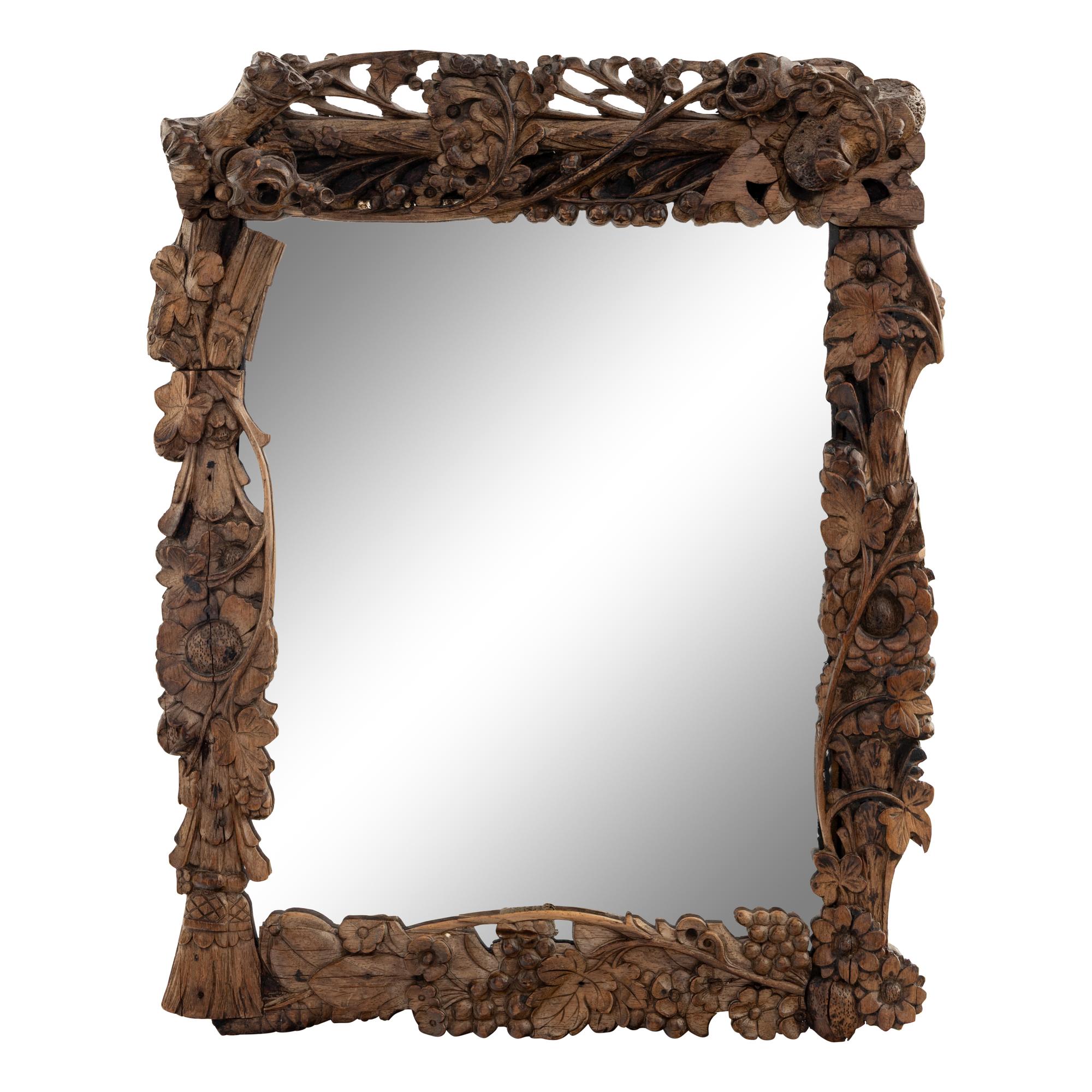 A Continental Carved Oak Mirror