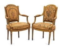 A Pair of French Neoclassical Painted and Parcel Gilt Armchairs