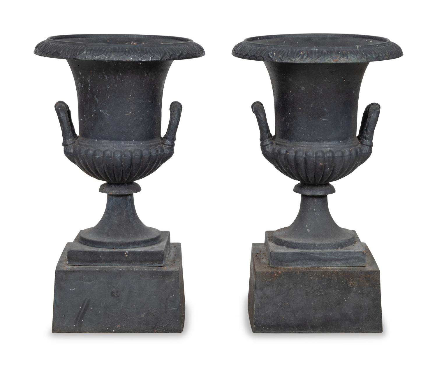 A Pair of Cast Iron Garden Urns and Plinths