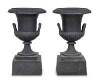 A Pair of Cast Iron Garden Urns and Plinths