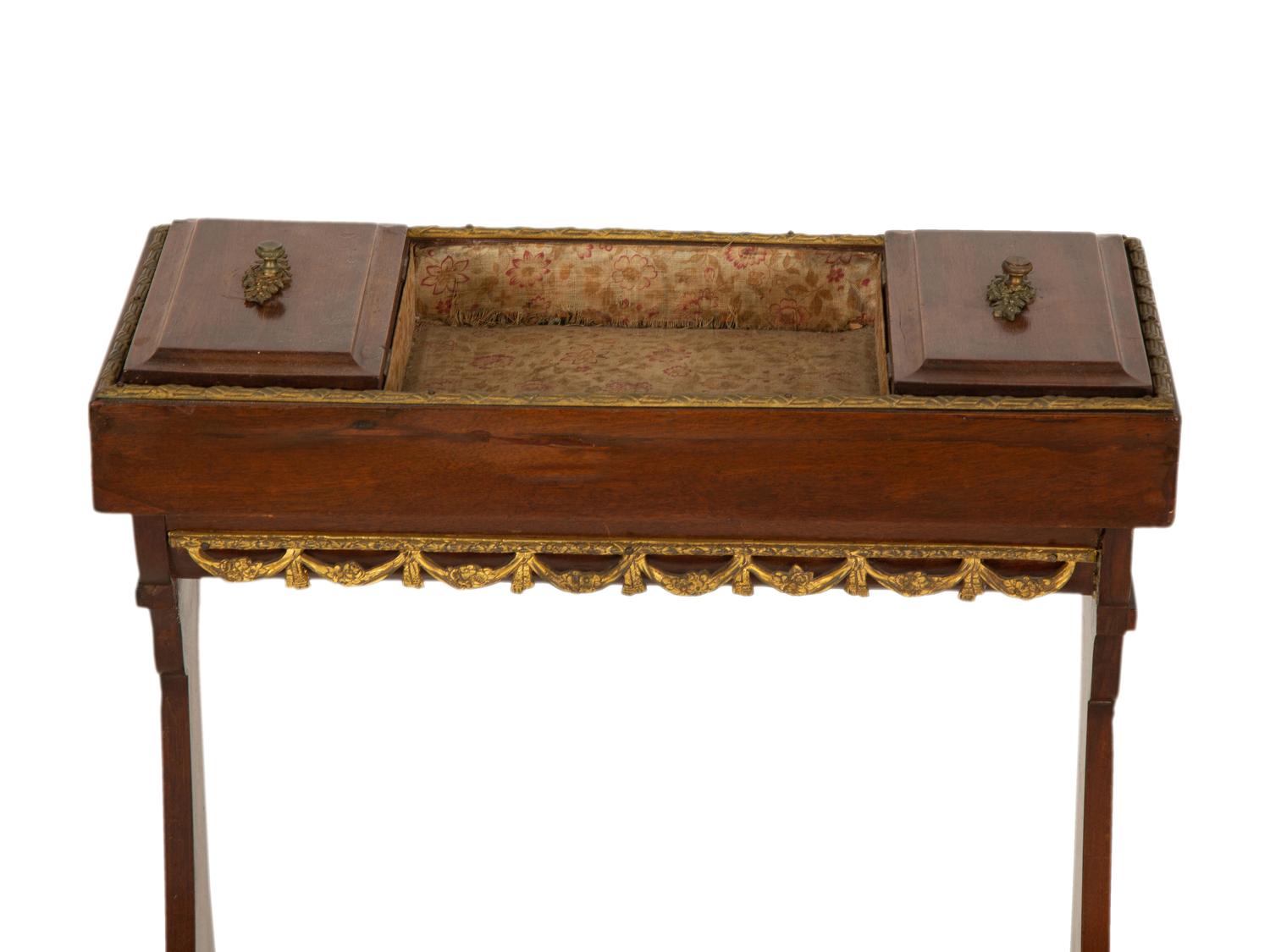 A French Empire Gilt Metal Mounted Mahogany Work Table