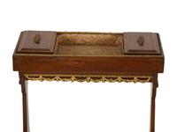 A French Empire Gilt Metal Mounted Mahogany Work Table