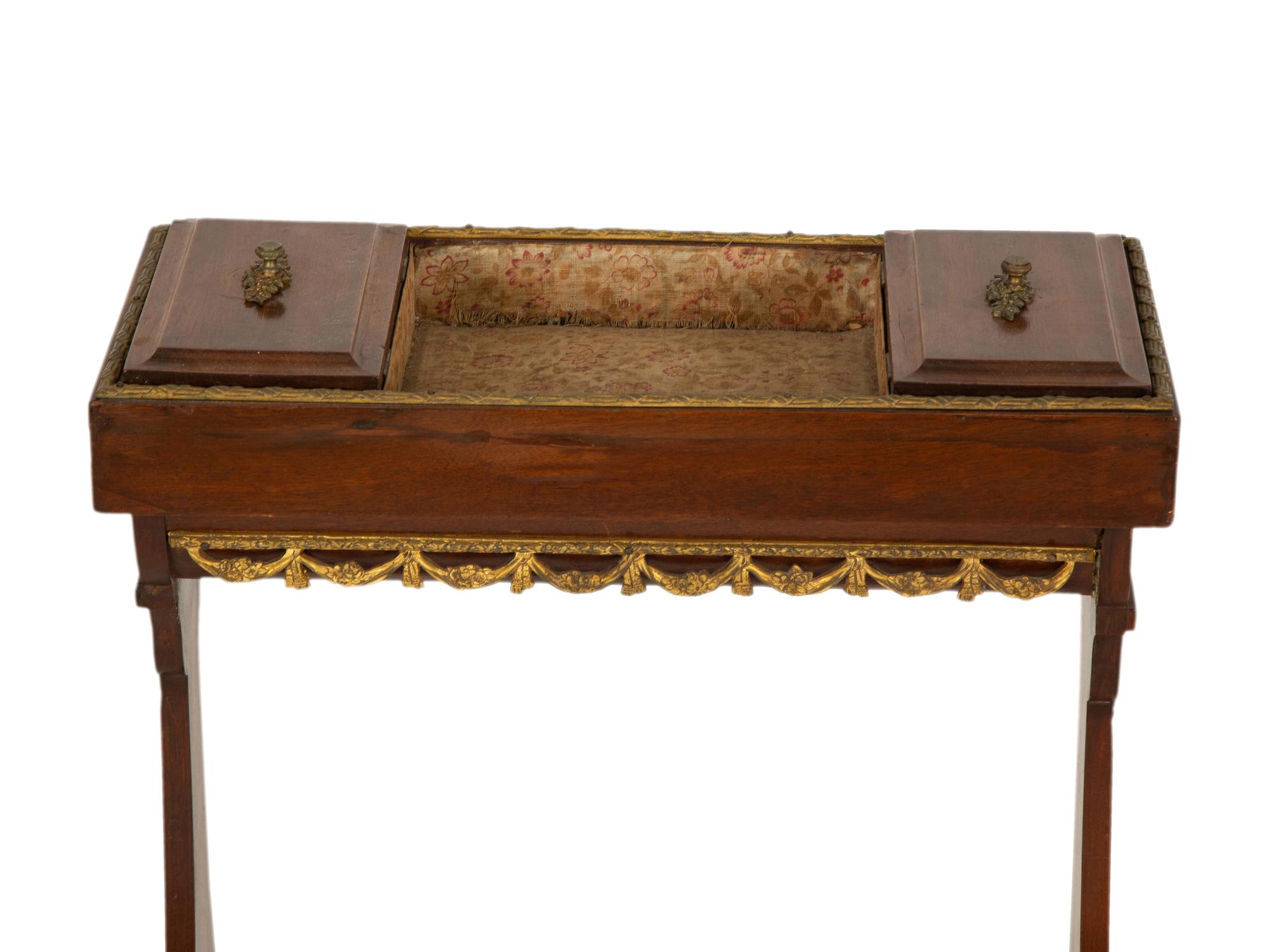 A French Empire Gilt Metal Mounted Mahogany Work Table