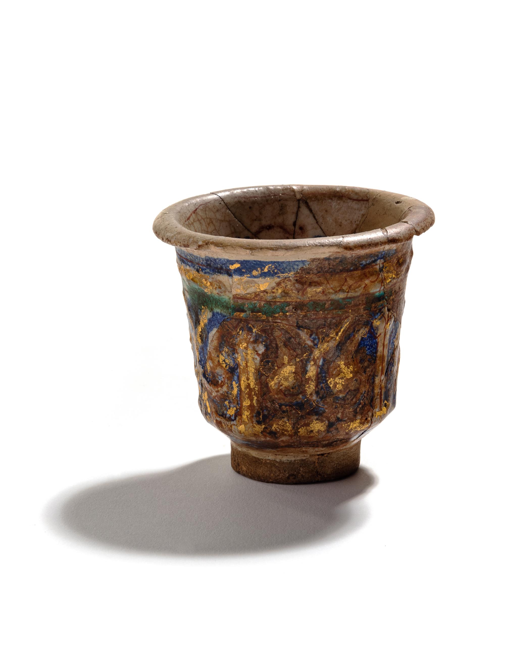 An Islamic Blue, Green and Iridescent Gold Glazed Pottery Cup