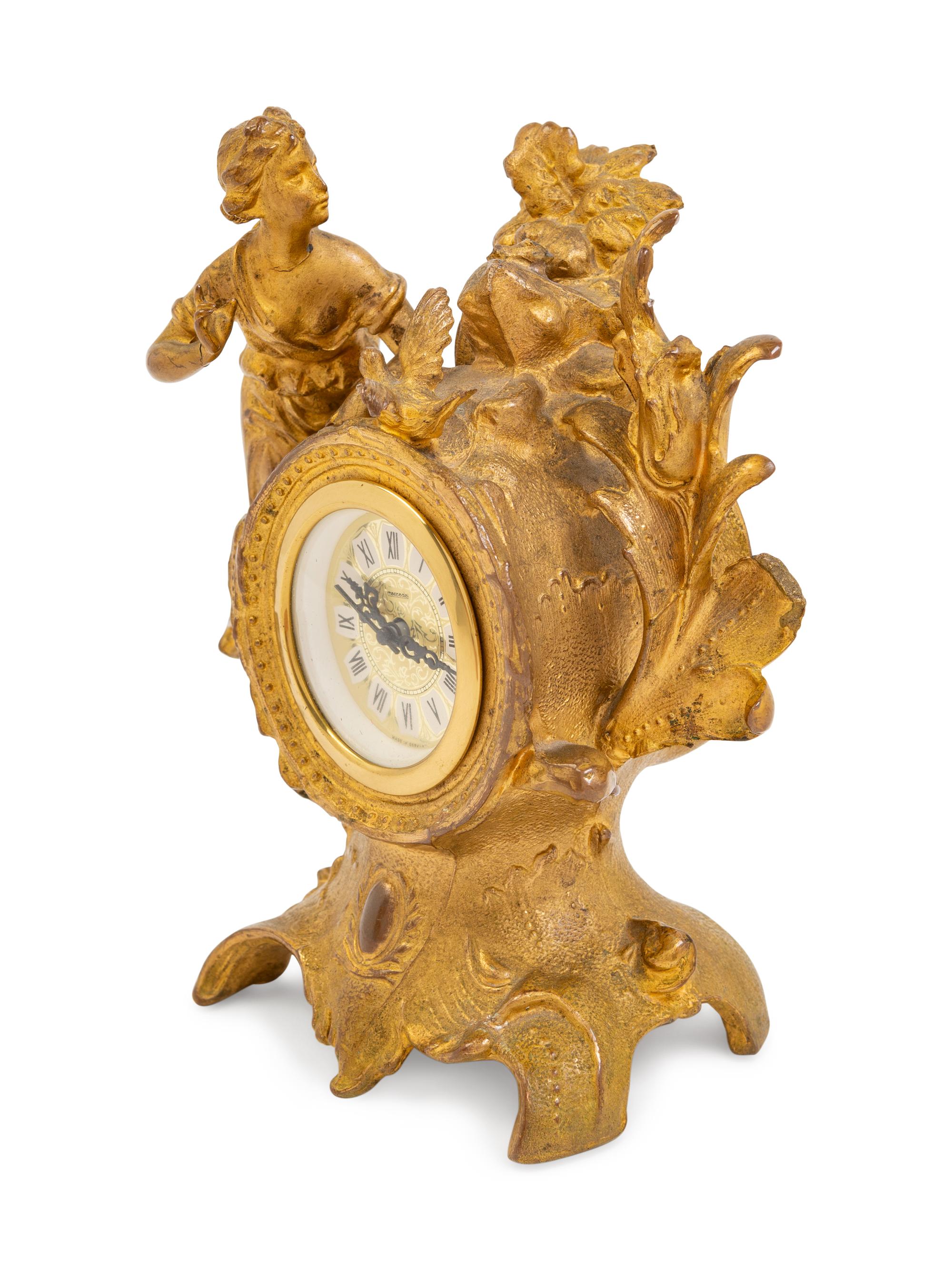 A Louis XV Style Gilt Metal Figural Clock with German Movement