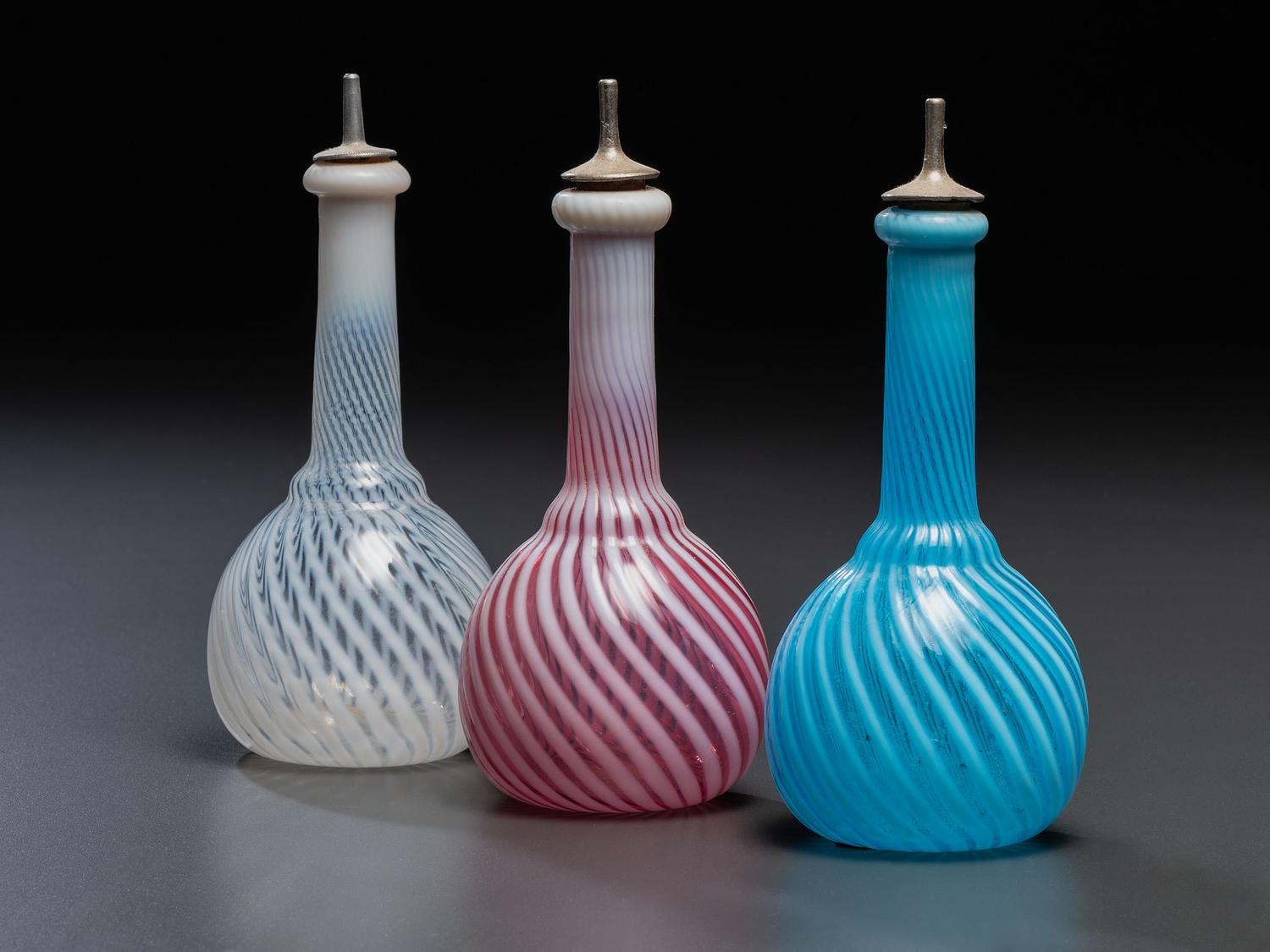 Three Opalescent Swirl Glass Barber Bottles