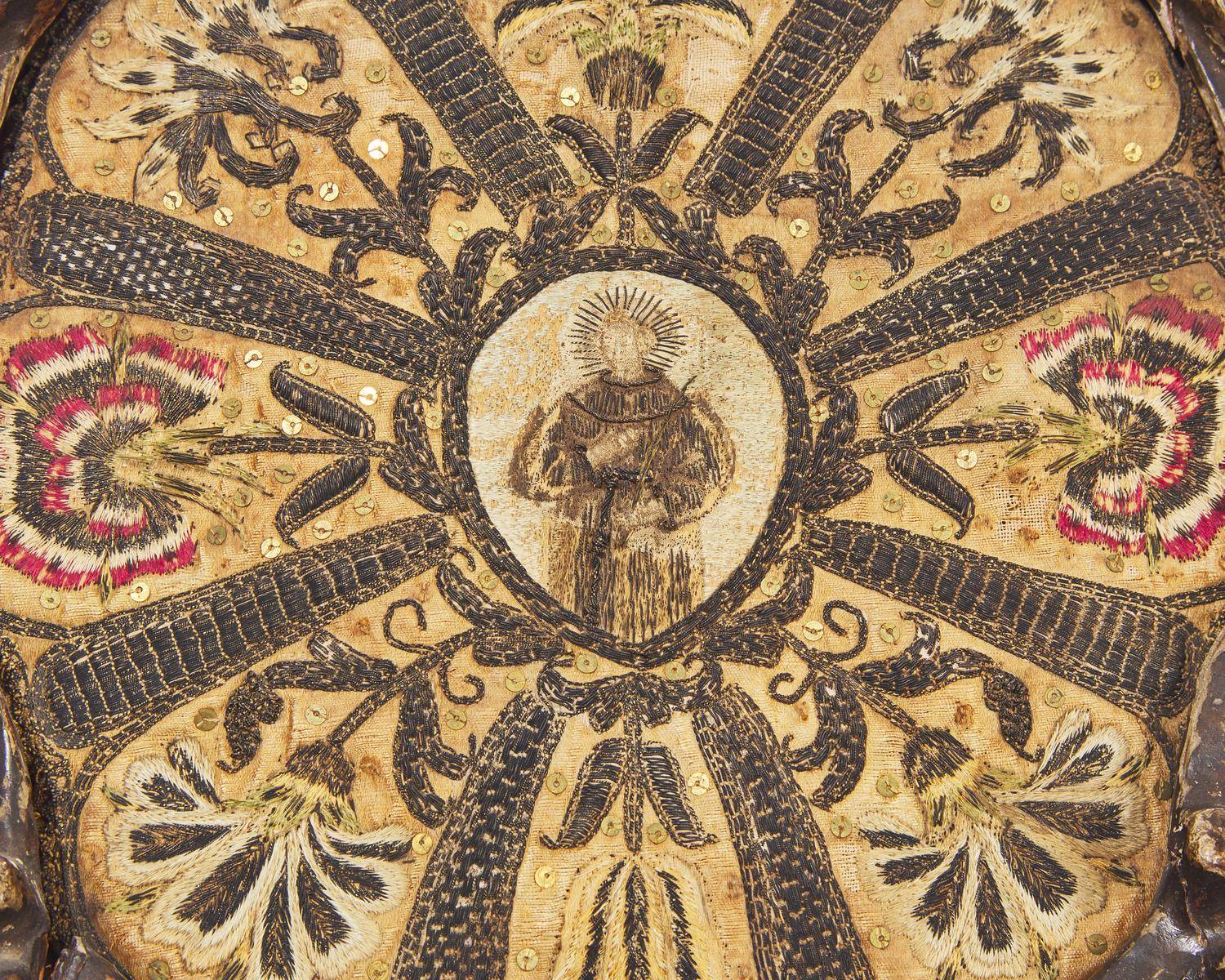 An Italian ecclesiastical embroidered silk roundel depicting a Saint, 18th century
