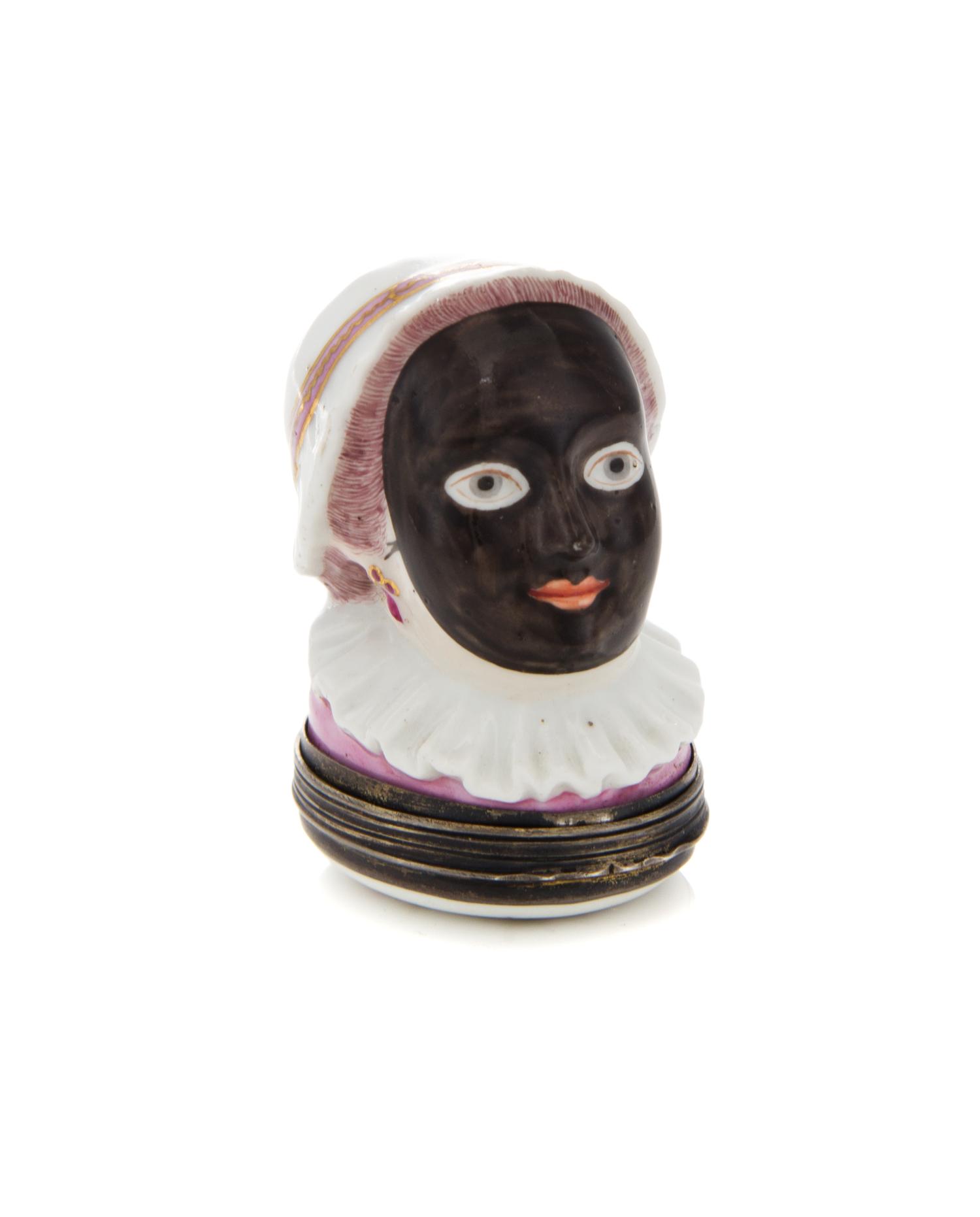 An English Silver Mounted Porcelain Bonbonniere, 19th Century, depicting a woman in a mask, hat and ruff.