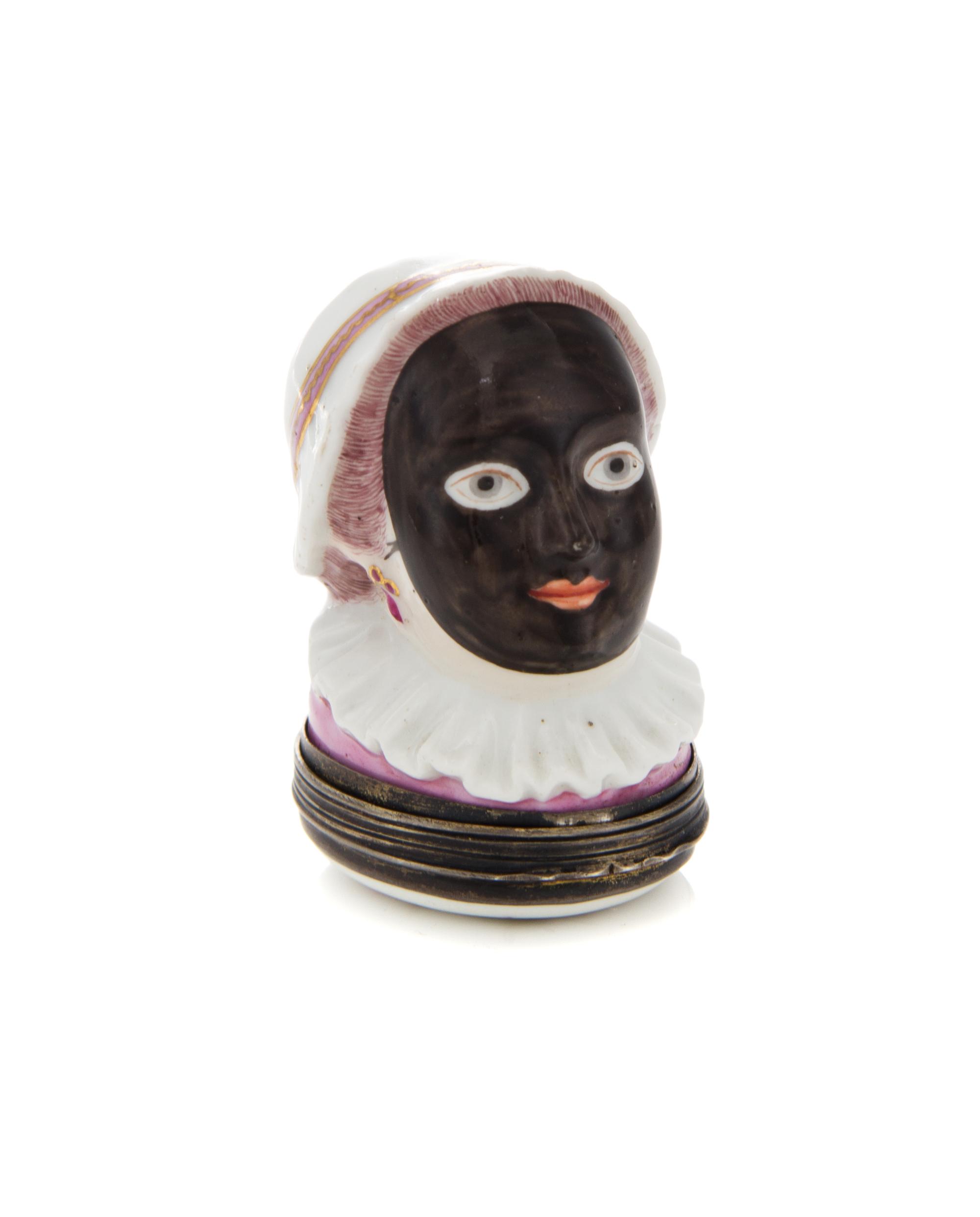 An English Silver Mounted Porcelain Bonbonniere, 19th Century, depicting a woman in a mask, hat and ruff.