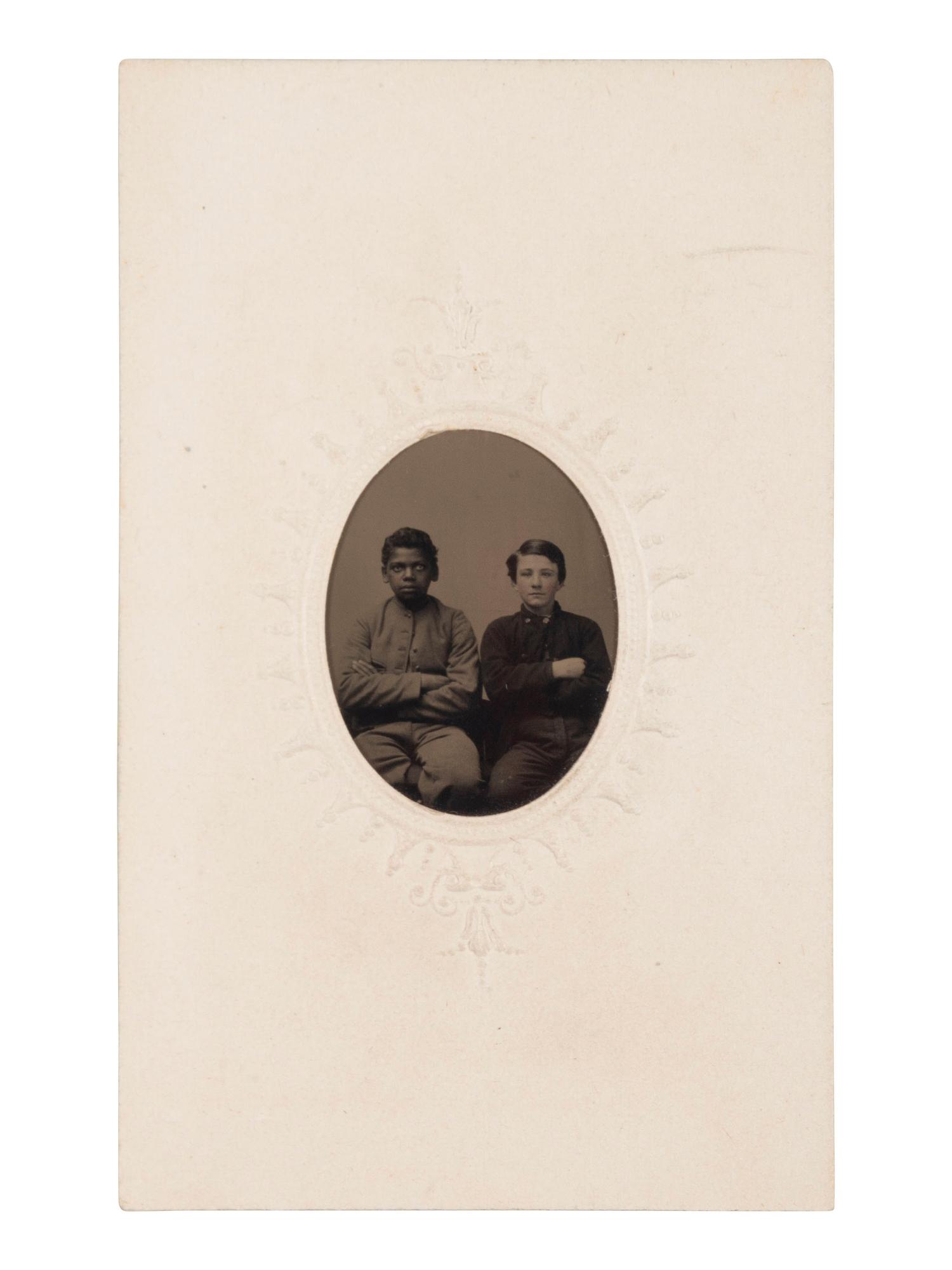 [AFRICAN AMERICANA - EARLY PHOTOGRAPHY]. Tintype of young African American and white male subjects seated together.