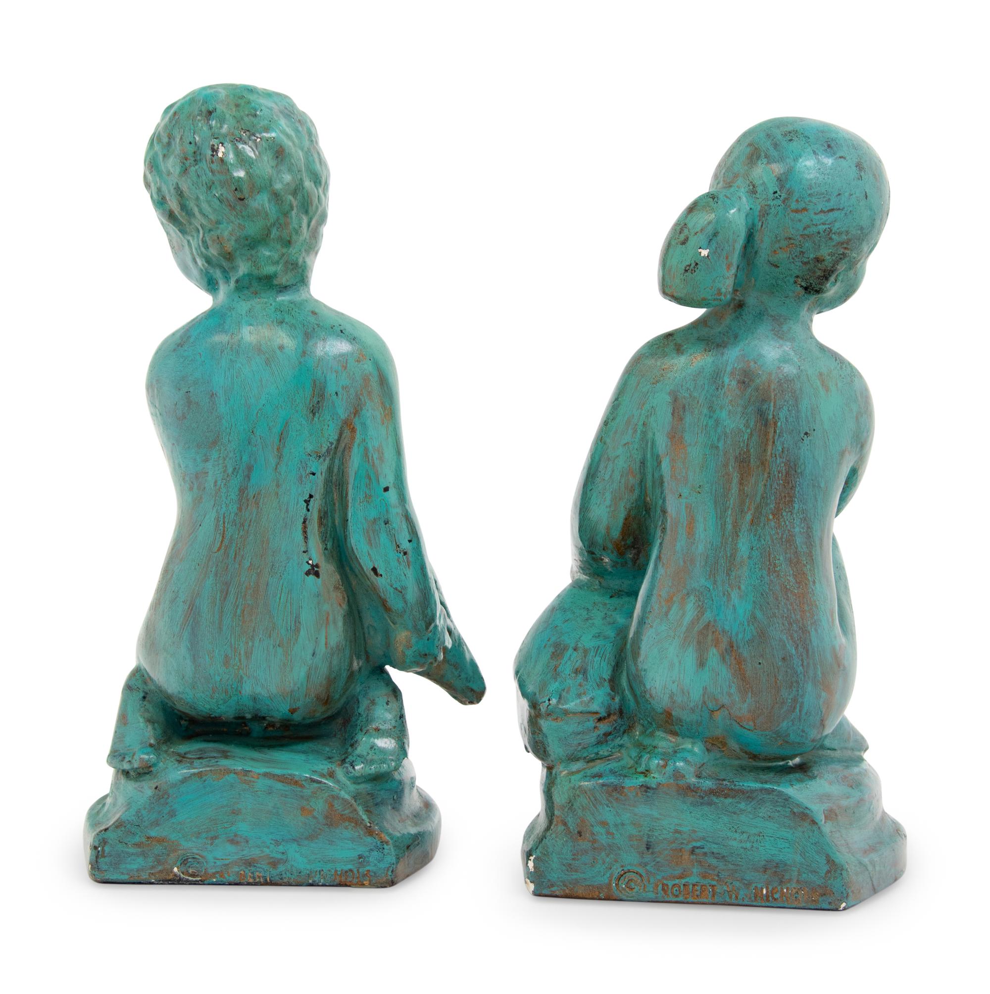 A Pair of Patinated Cast Metal Figures