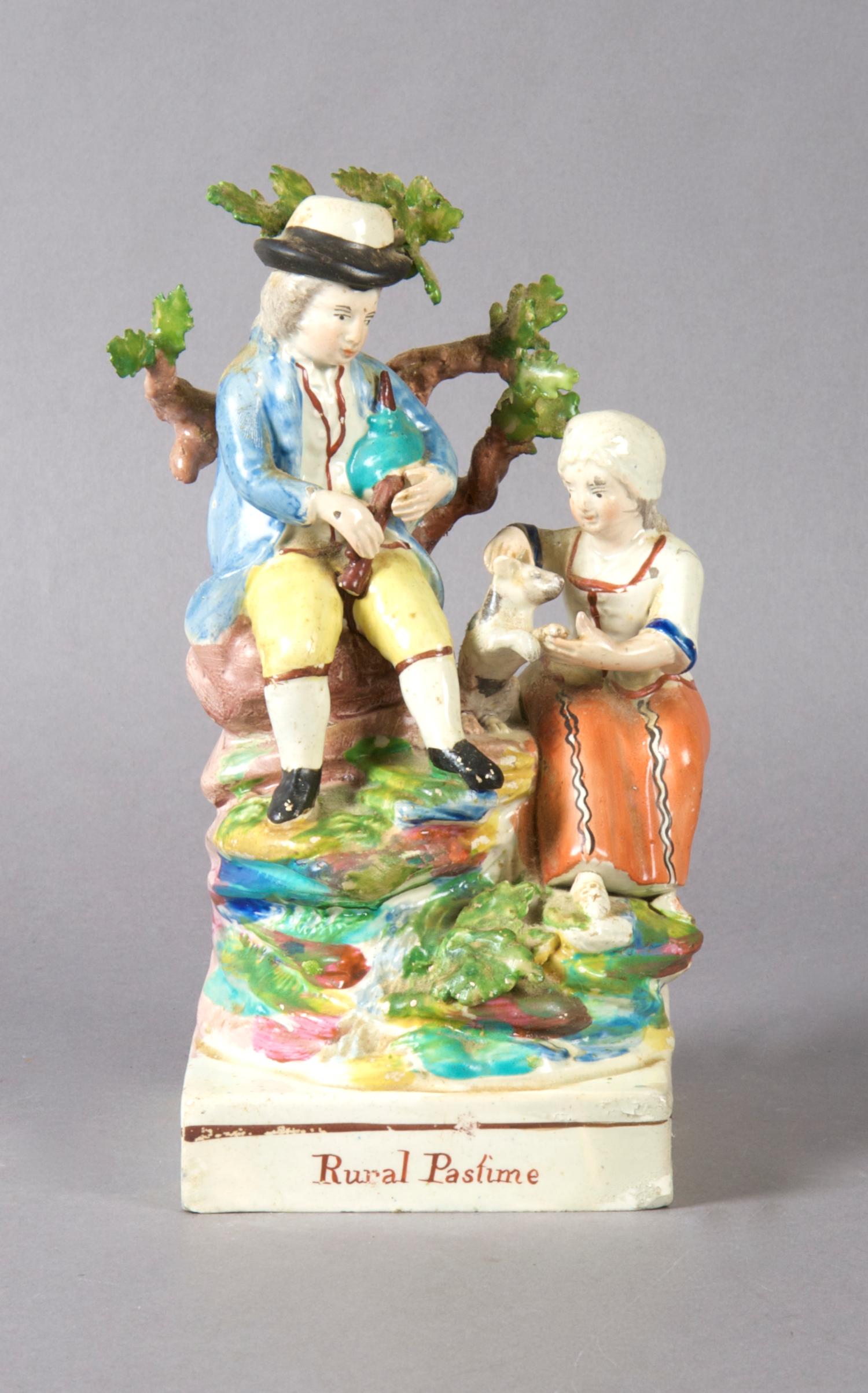 A Staffordshire Figural Group, Rural Pastime, Height 8 inches.