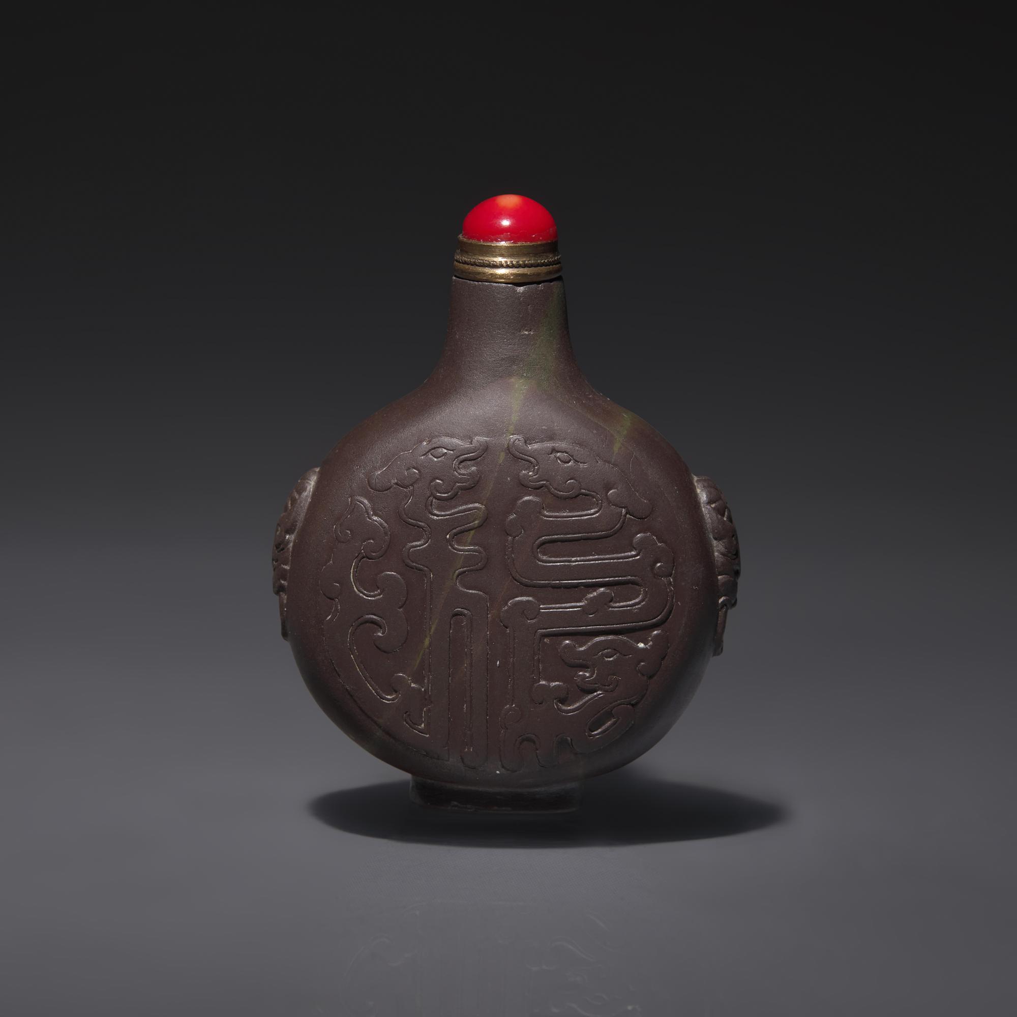 A Chinese Carved Duan Stone Snuff Bottle, Qing Dynasty, Circa 1800-1850 — 1800–1850年 端石雕龍紋鼻煙壺