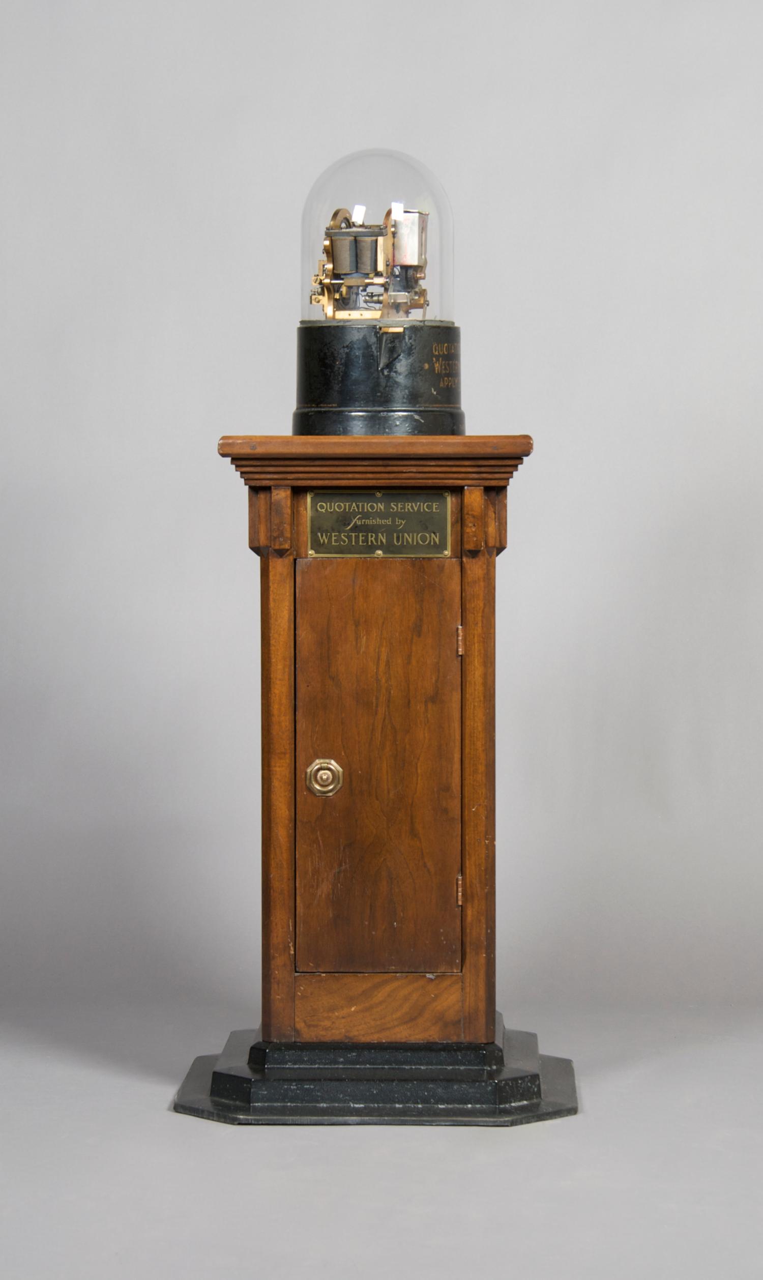 A Western Union Telegraph Company Stock Ticker with Base, Height of ticker 13 1/4 inches, height overall 43 inches.