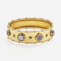 An Antique Yellow Gold Bangle Bracelet with Applique Charms