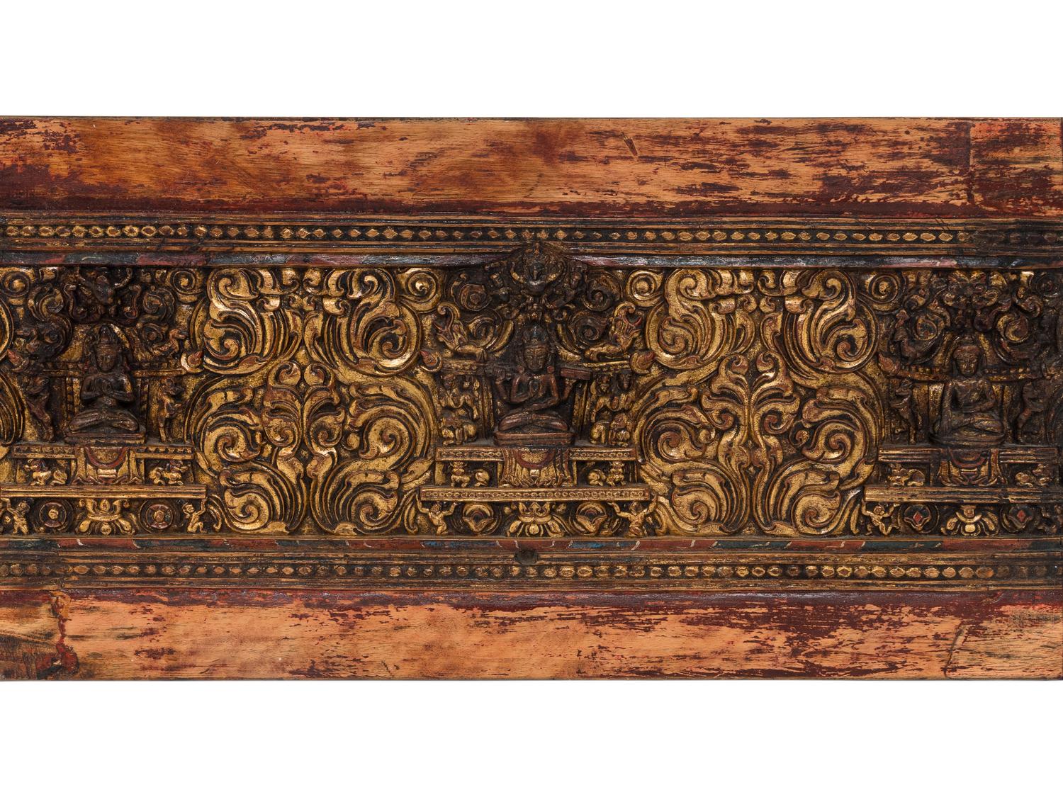 A Tibetan Gilt Lacquered and Polychromed Wood Manuscript Cover