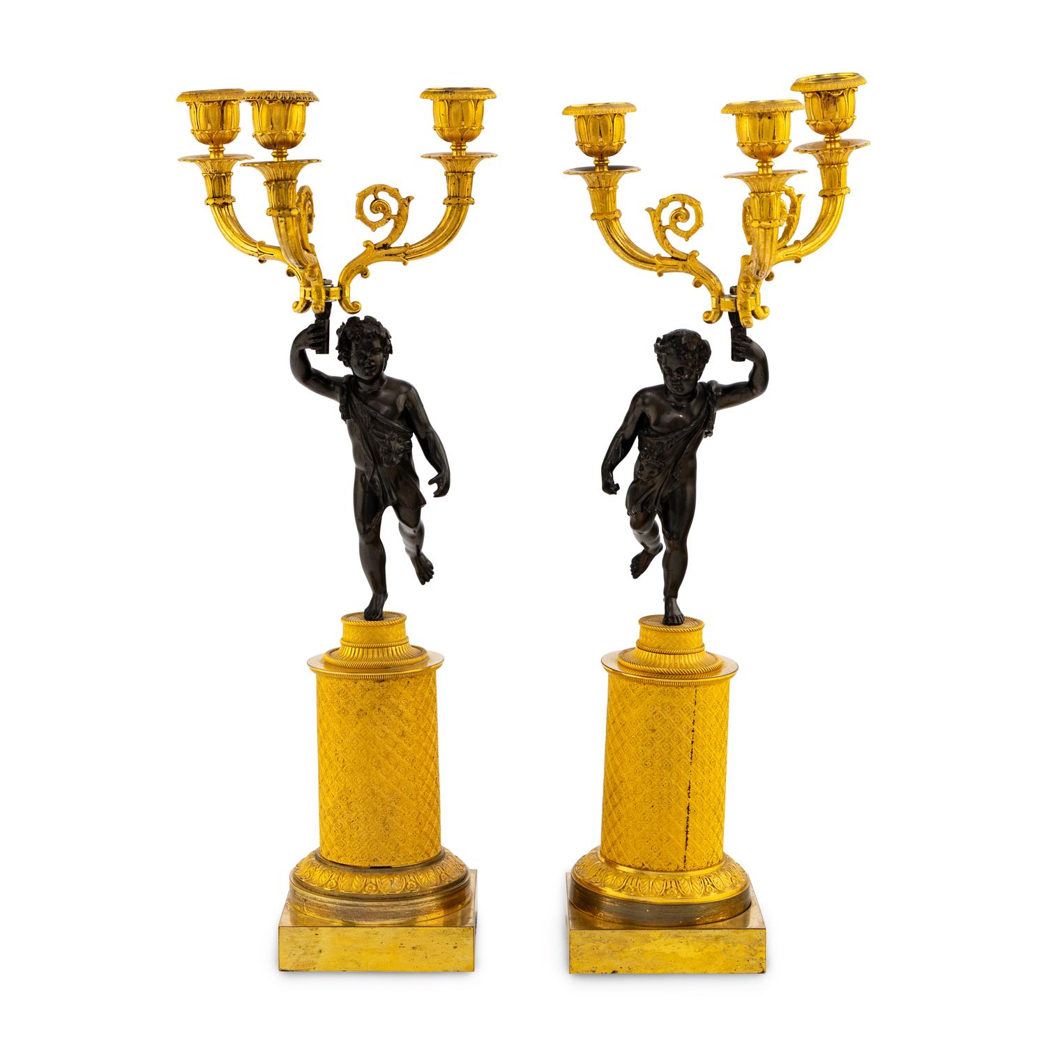 A Pair of French Gilt and Patinated Bronze Three-Light Candleabra