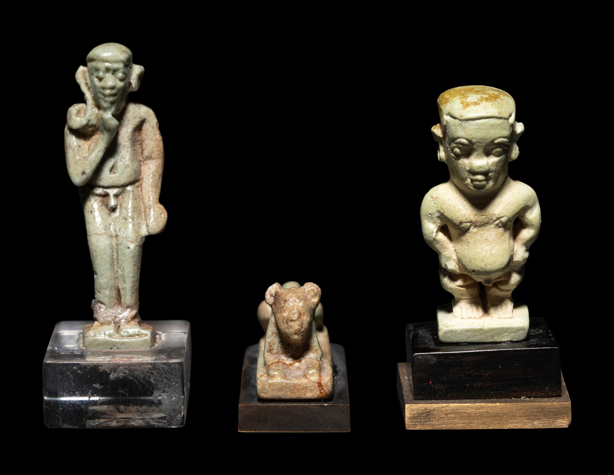 Three Egyptian Faience Amulets Including a Pataikos, a Harpocrates, and a Recumbent Lion