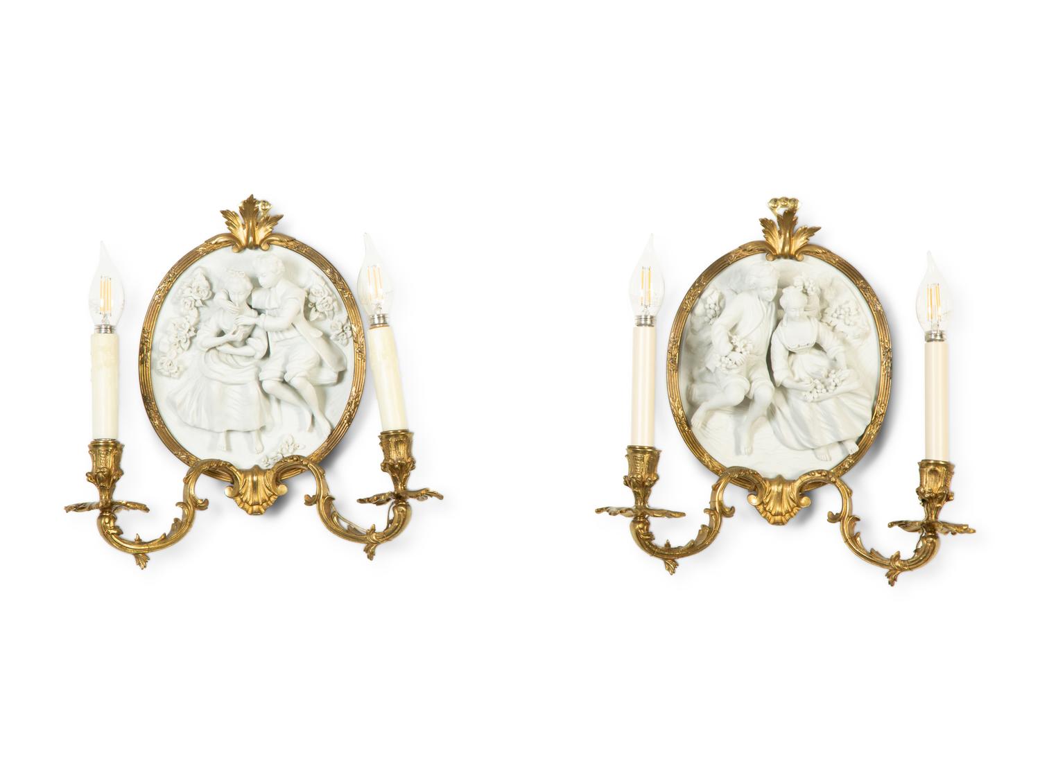 A Pair of Continental Plaster Relief Medallion and Gilt Bronze Two-Light Sconces