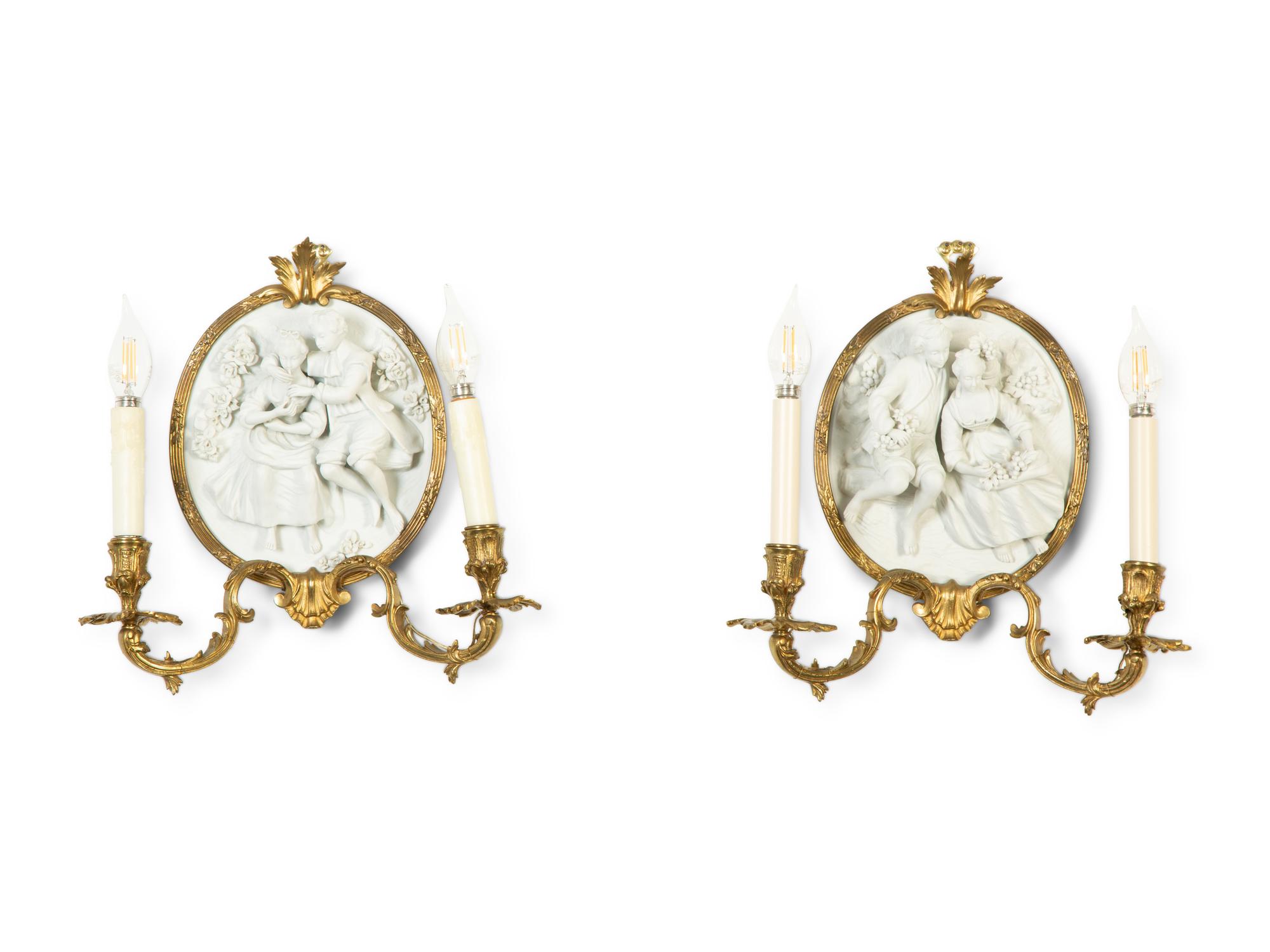 A Pair of Continental Plaster Relief Medallion and Gilt Bronze Two-Light Sconces