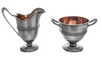 An American Silver Creamer and Footed Bowl, Tiffany & Co., New York, NY, each having a foliate decorated band along the body and foot,