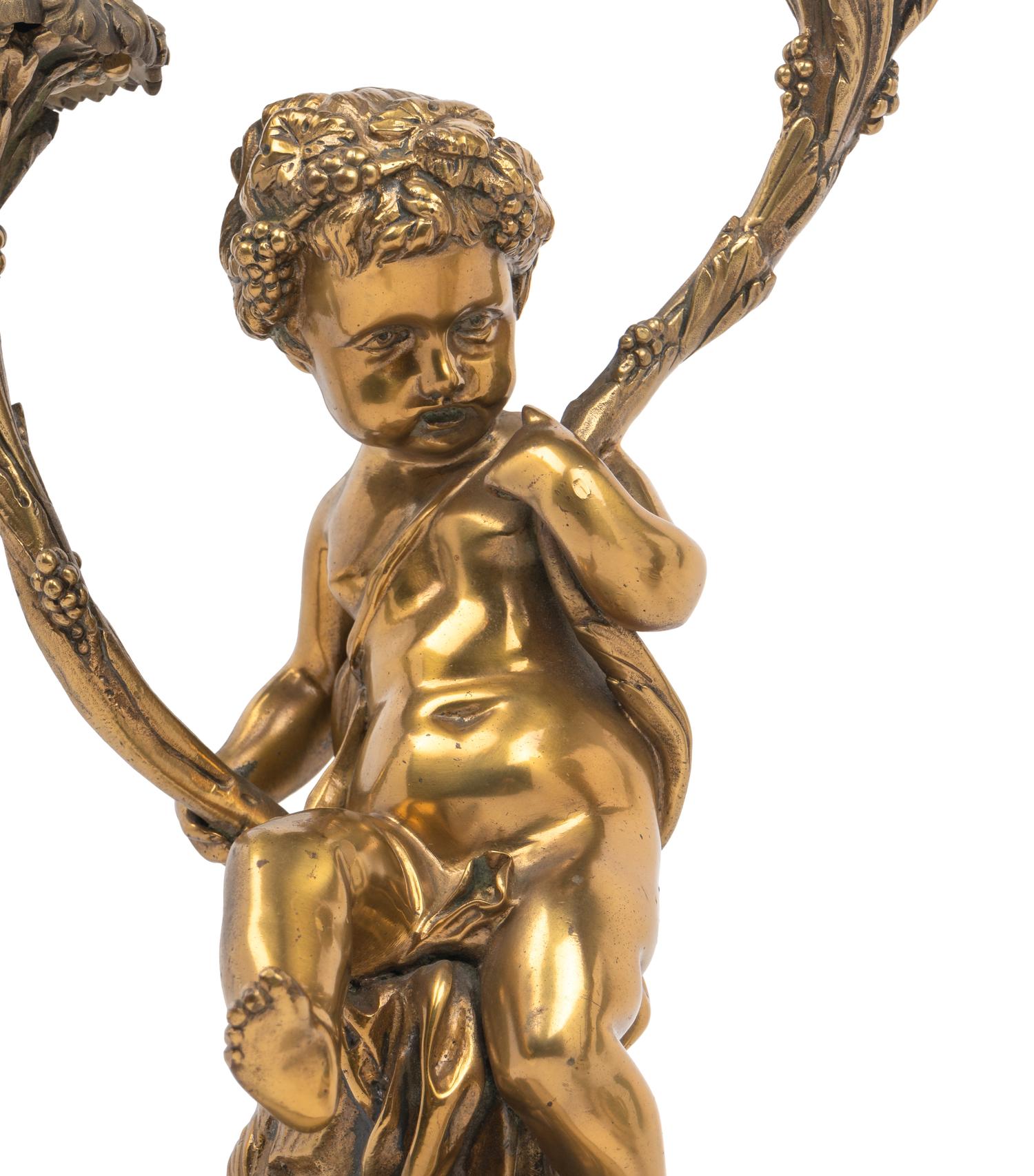 A Pair of French Gilt Bronze and Marble Figural Two-Light Candelabra