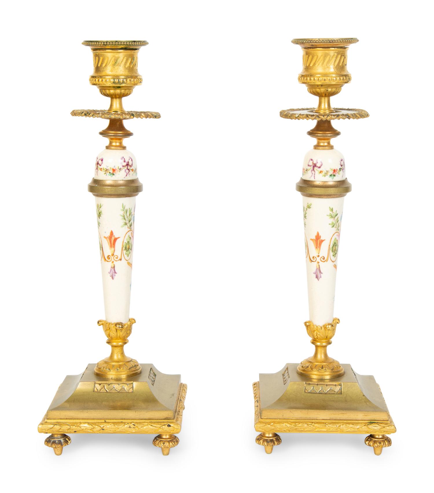 A Pair of French Gilt Bronze and Painted Porcelain Candlesticks