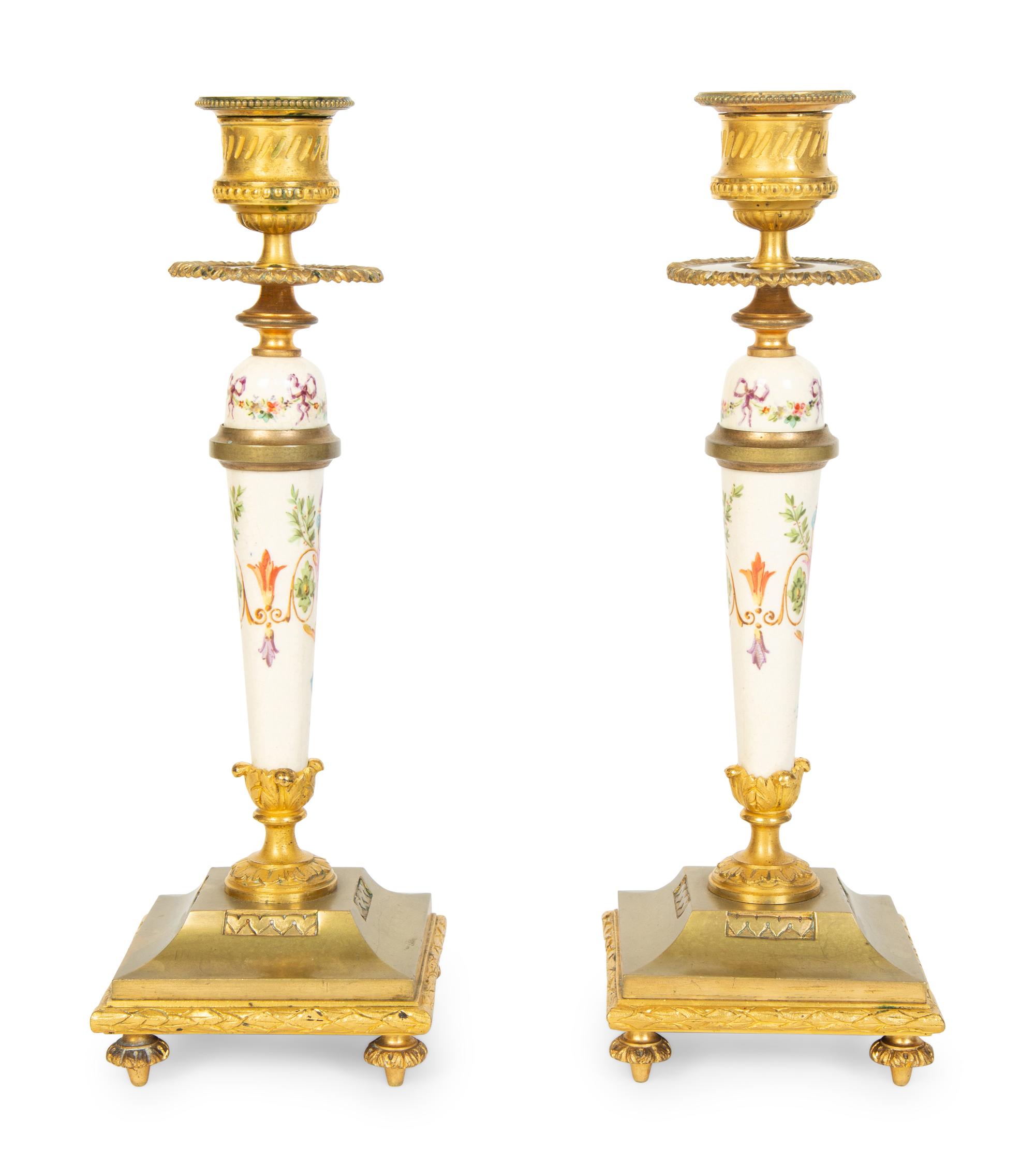 A Pair of French Gilt Bronze and Painted Porcelain Candlesticks