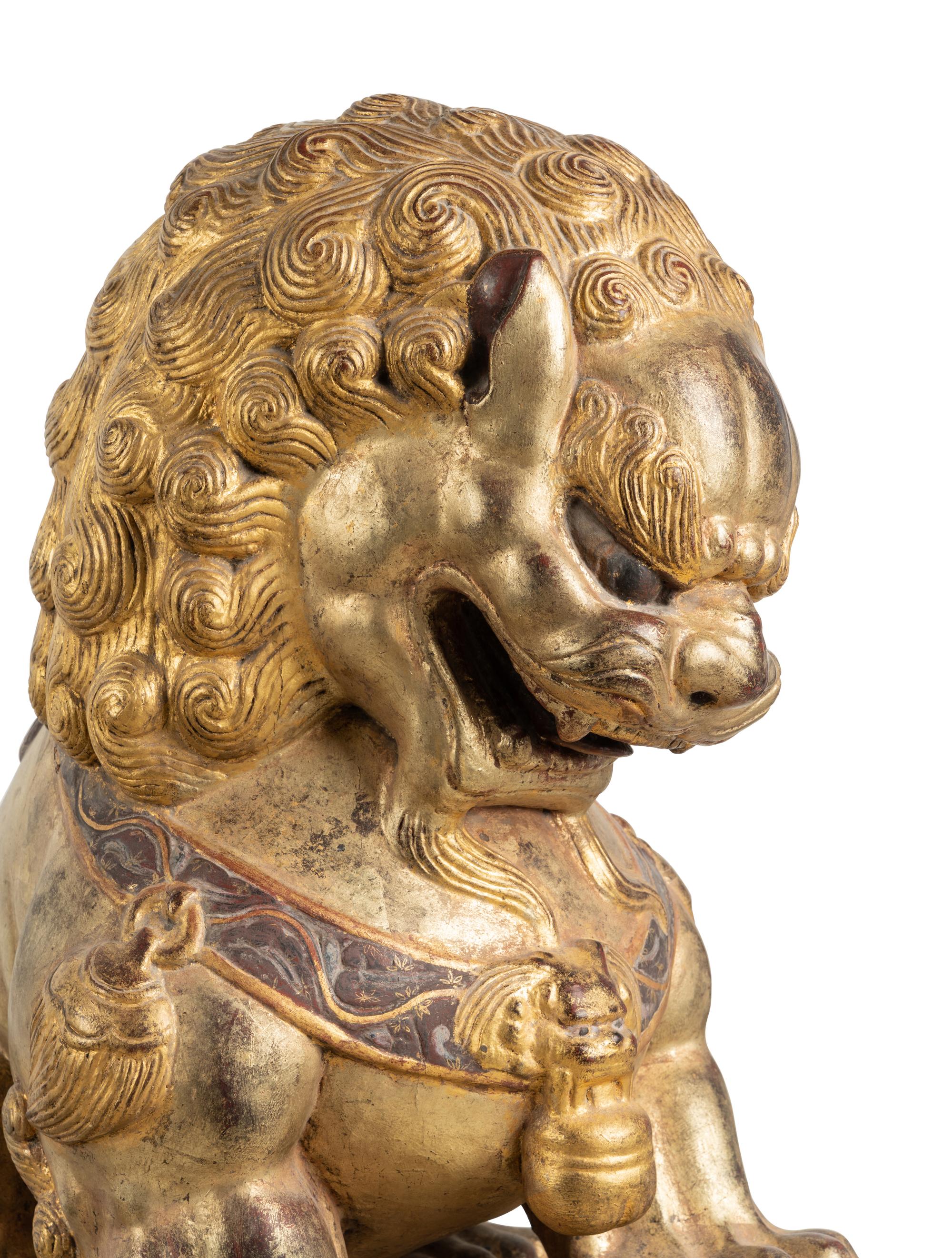 A Pair of Large Chinese Giltwood and Composition Buddhistic Lions